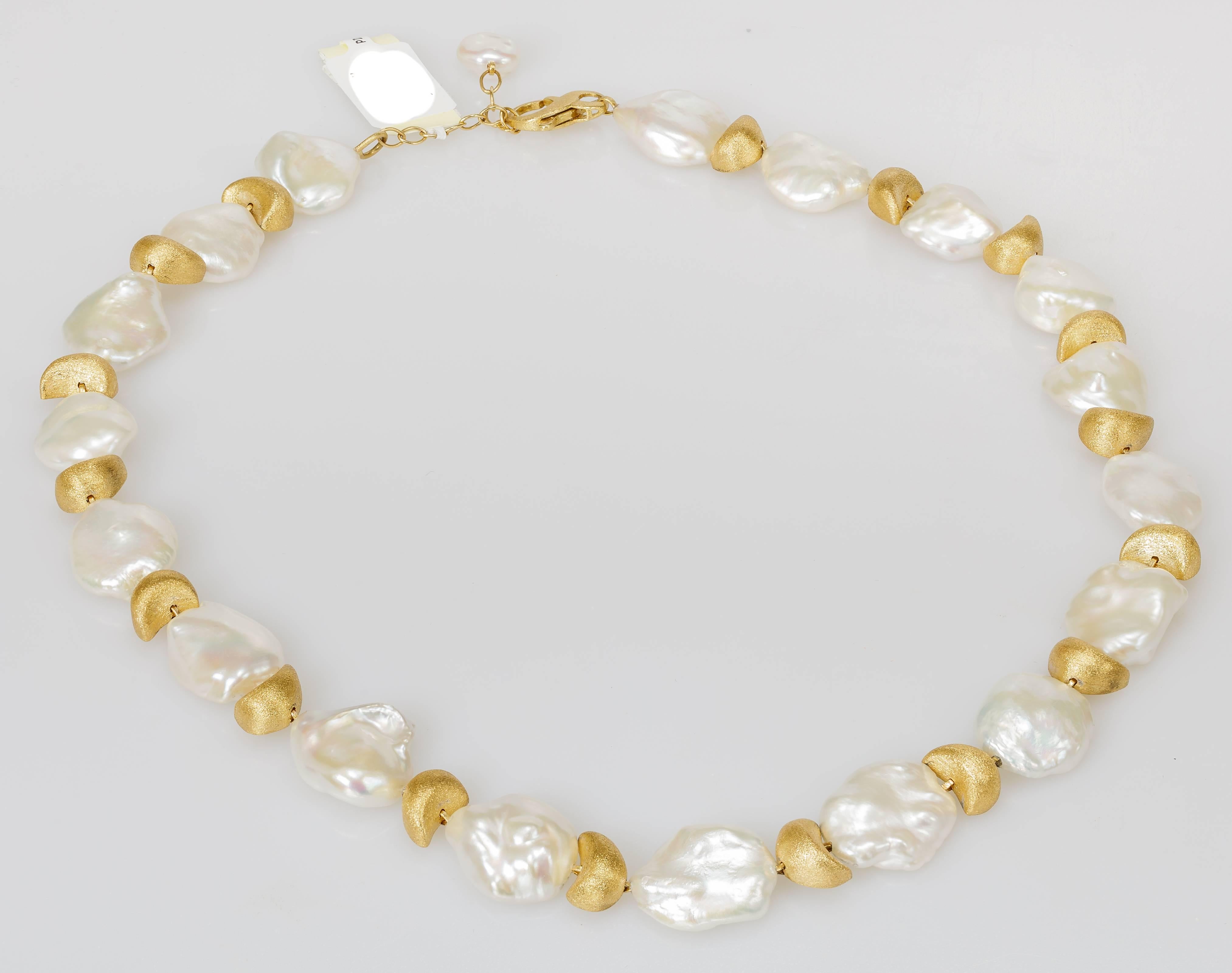 This Yvel necklace features freshwater keshi pearls alternating with 18k yellow gold beads.  The necklace measures 18 inches long.