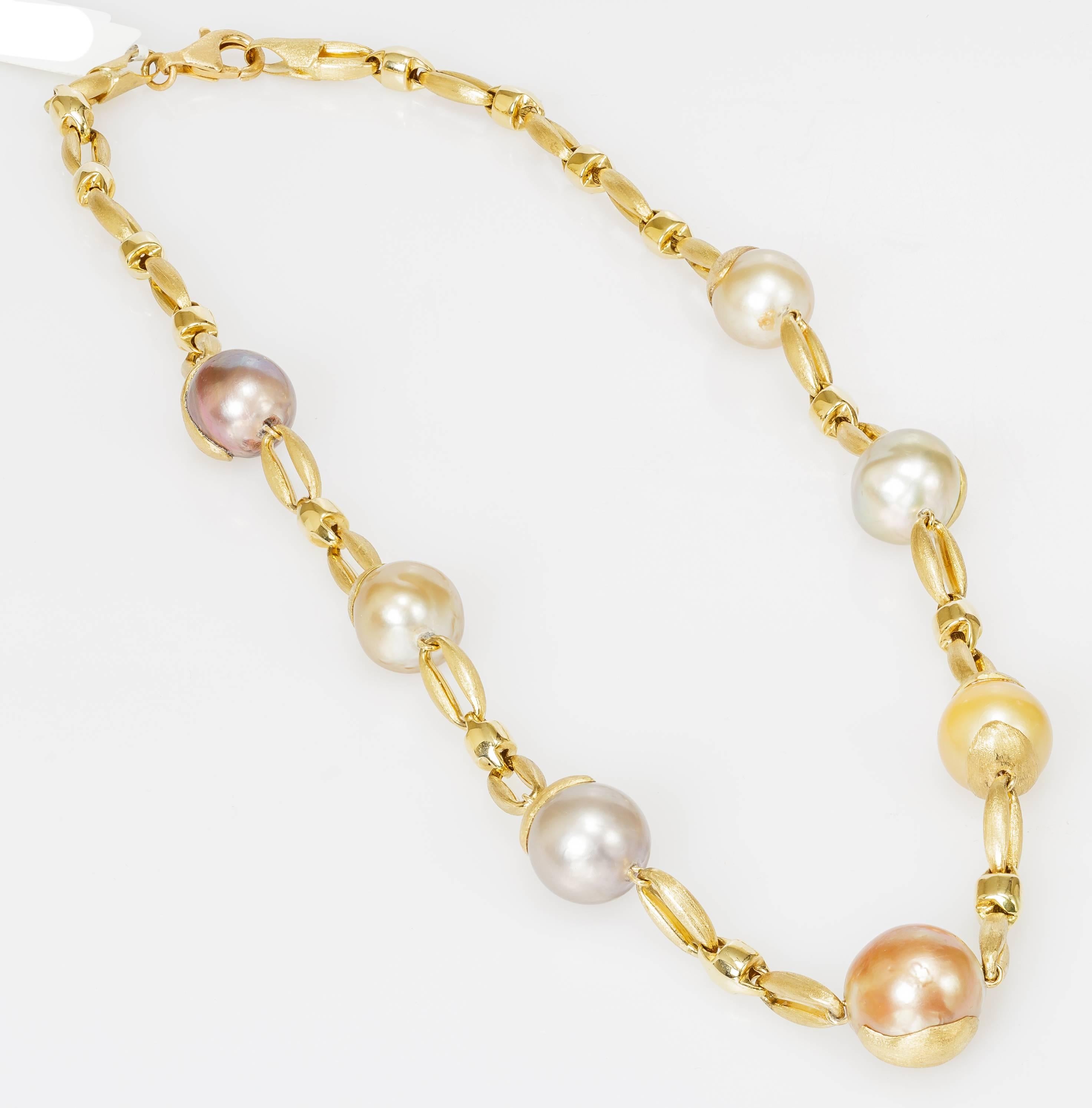 This Yvel necklace features multicolored South Sea pearls linked by 18k yellow gold.  The necklace measures 18 inches long.