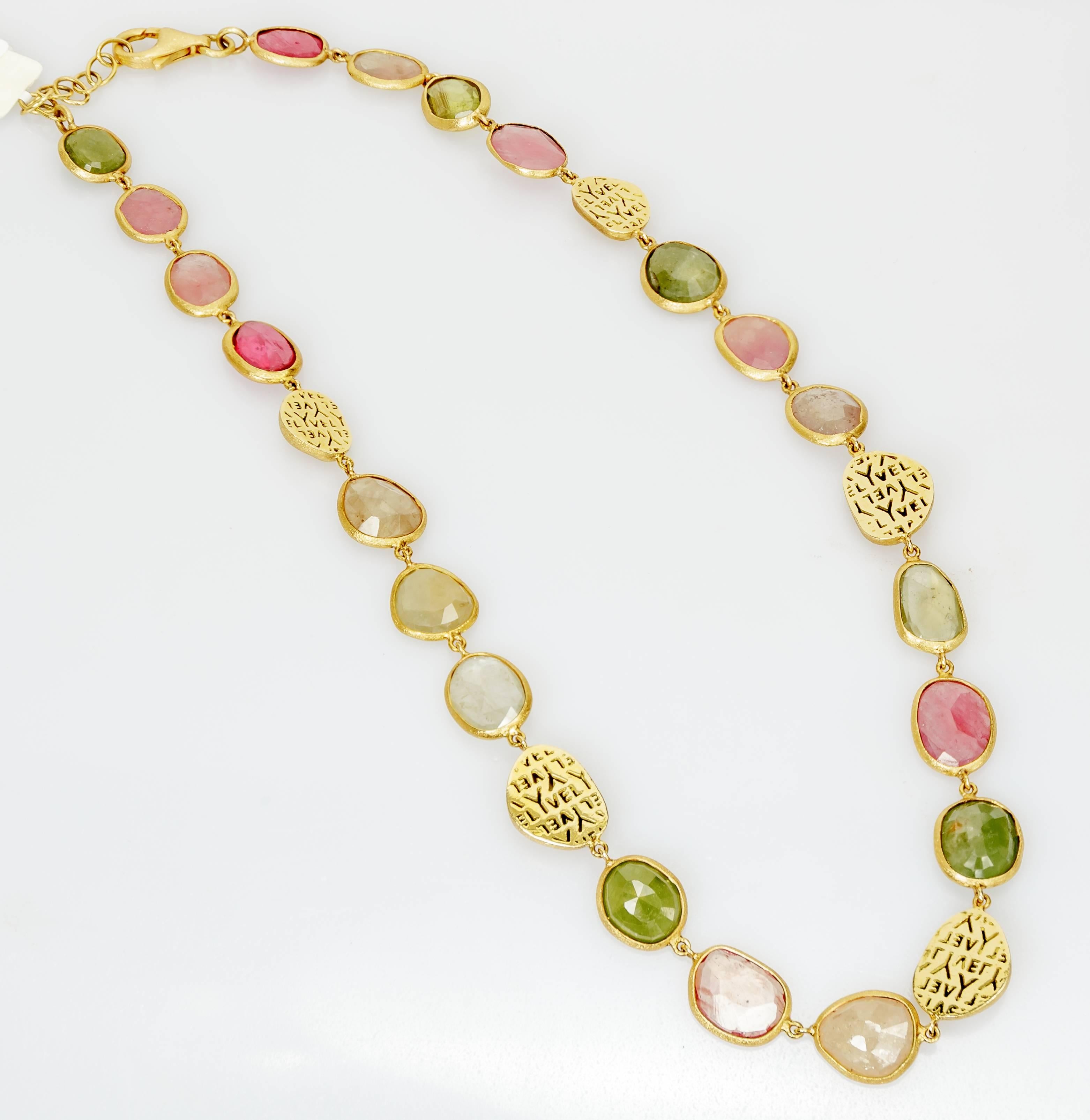 This 18k yellow gold necklace has 20 natural fancy colored faceted sapphires interspersed with gold beads that say Yvel. Reversible. It measure 15 inches. 