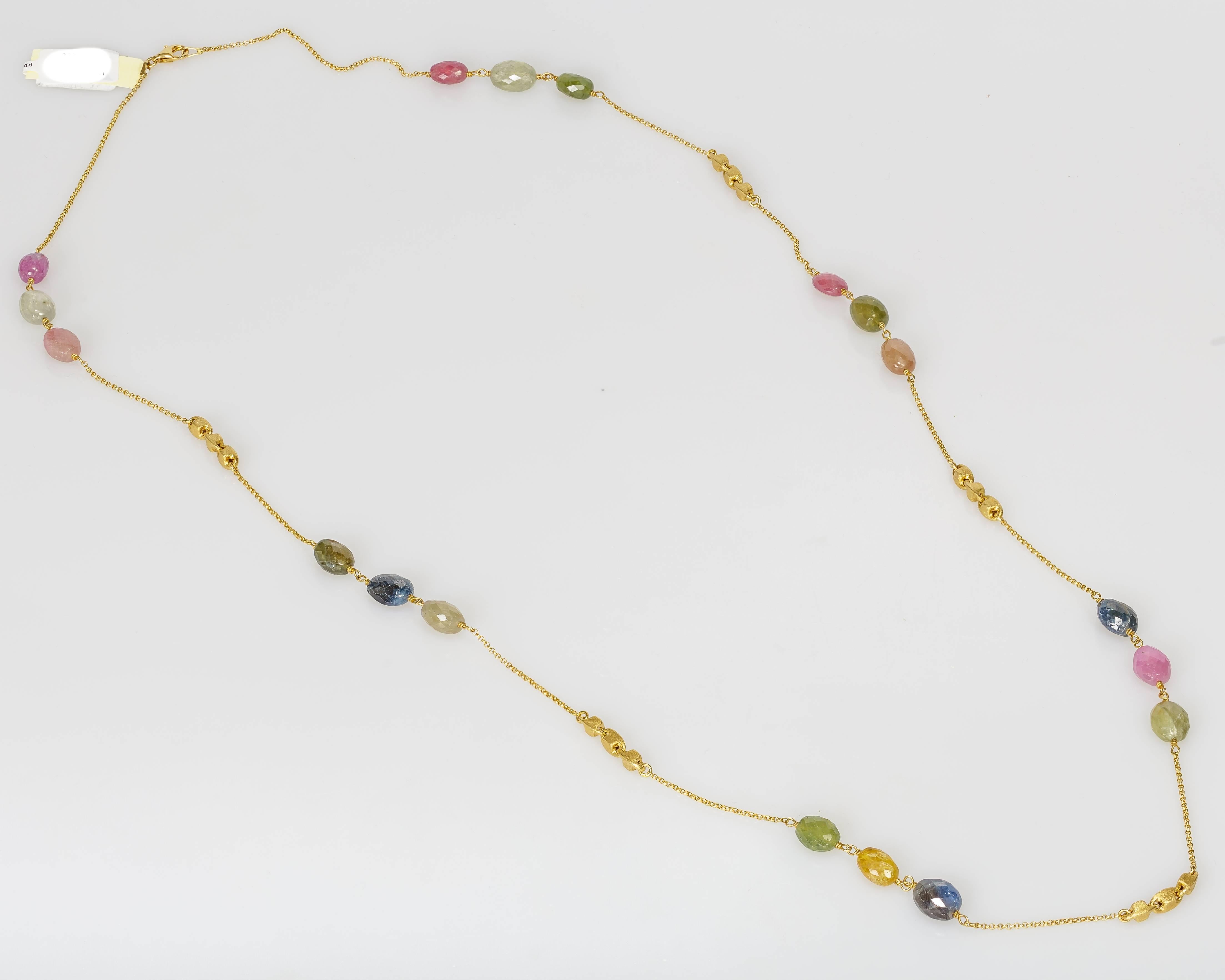 This Yvel necklace features 93.00 ct. of natural fancy colored rose cut sapphire beads linked by a 32 inch 18k yellow gold chain. It can be worn long, or doubled (see photos). 