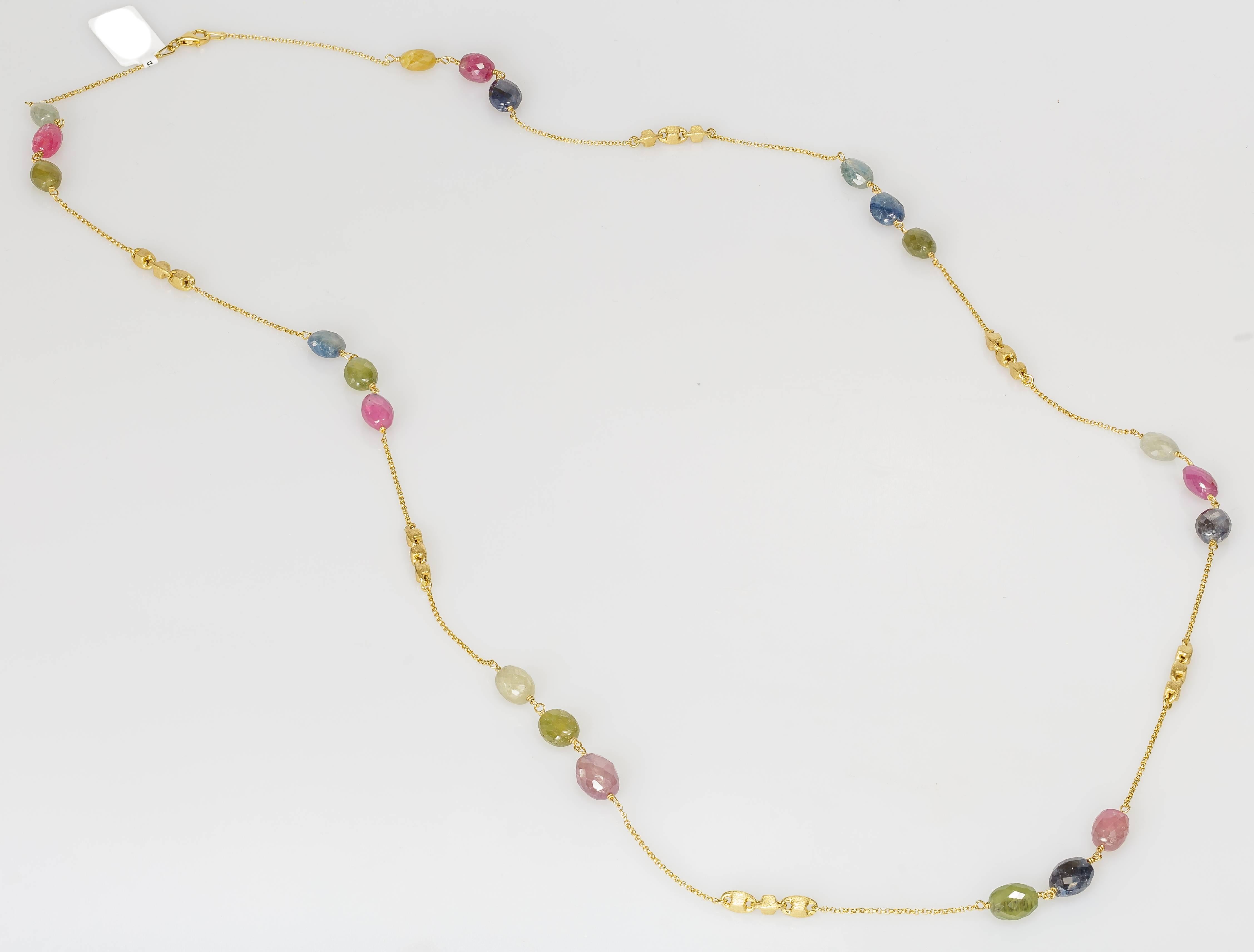This Yvel beaded chain necklace features natural fancy colored sapphire rose cut beads linked by a 36 inch long 18k yellow gold chain. This necklace can be worn long or doubled for a shorter length. 