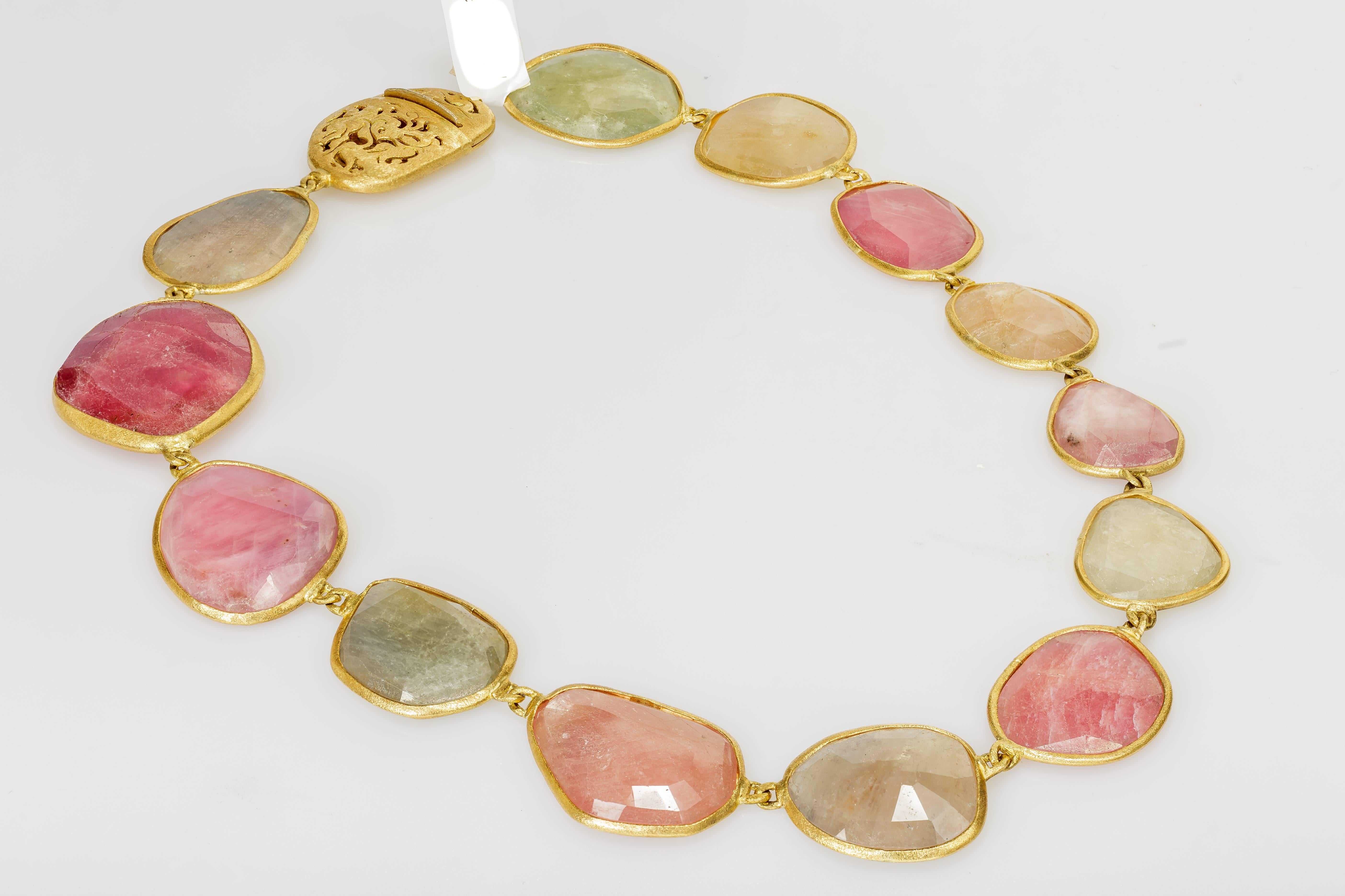 This Yvel necklace features natural fancy colored rose cut sapphires linked by 18k yellow gold.  The necklace measures 18 inches long.