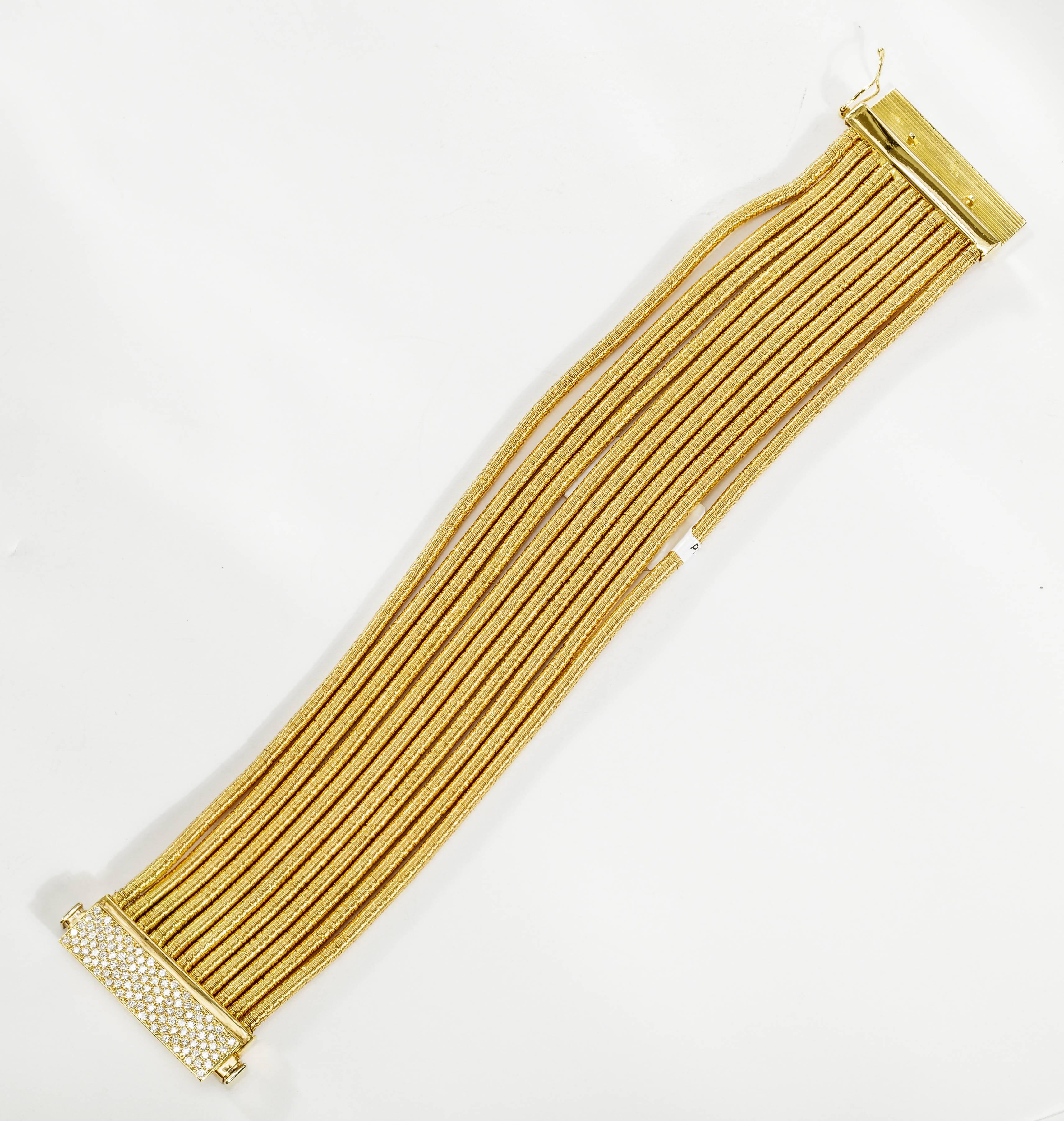 This 18k yellow gold Yvel bracelet has 11 flexible strands and is set with pavé diamonds totaling 1.10 ct.  The bracelet measures 6.5 inches. 