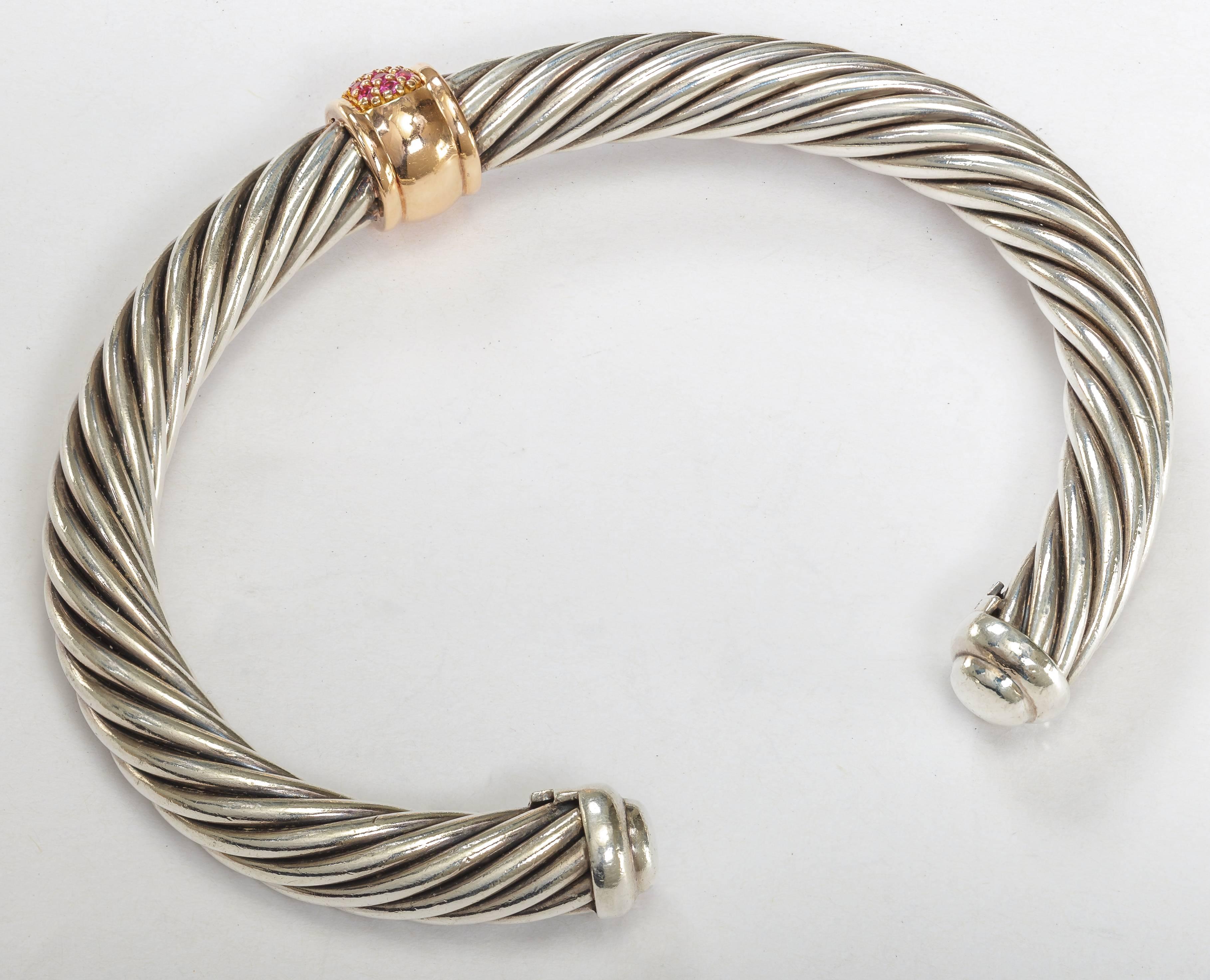 Measures 7mm wide. Set with 25 round pink sapphires.