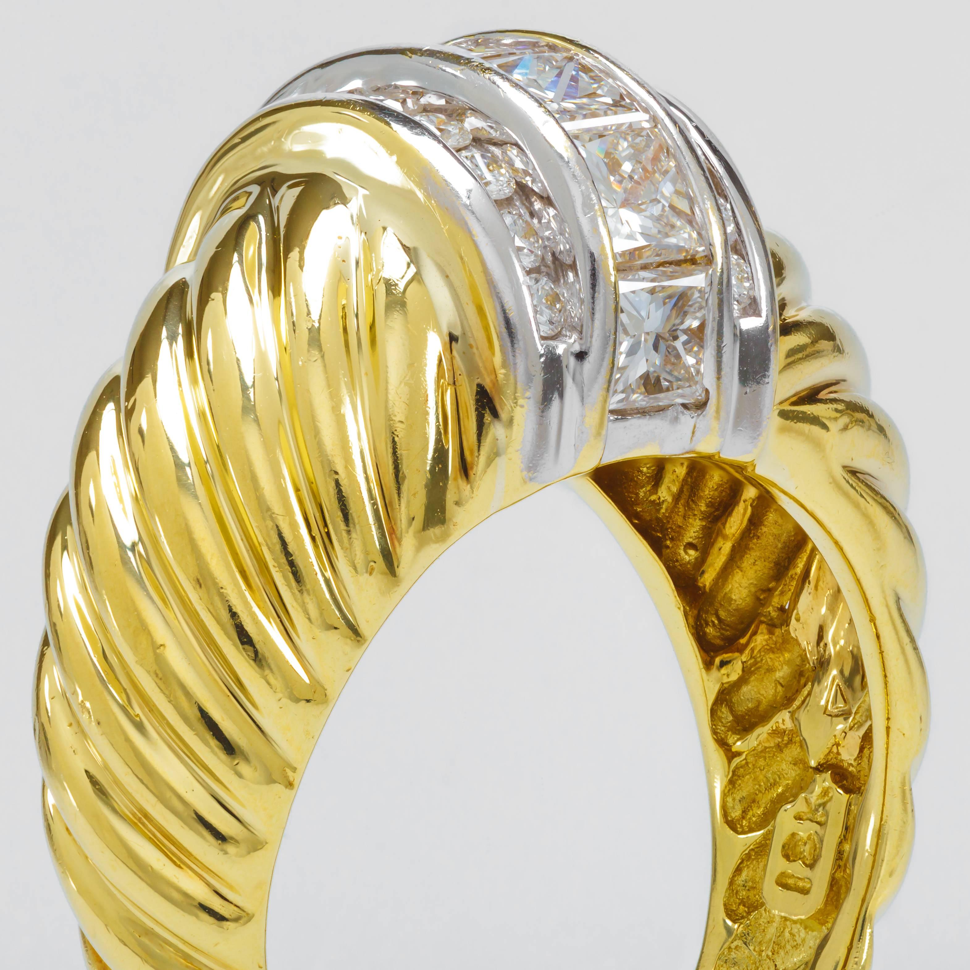 This David Yurman dome cable ring in 18K yellow gold and sterling silver features 7 princess cut diamonds totaling approximately 0.86 ct. and 20 round diamonds totaling approximately 0.70 ct.  The inside of the band is stamped 