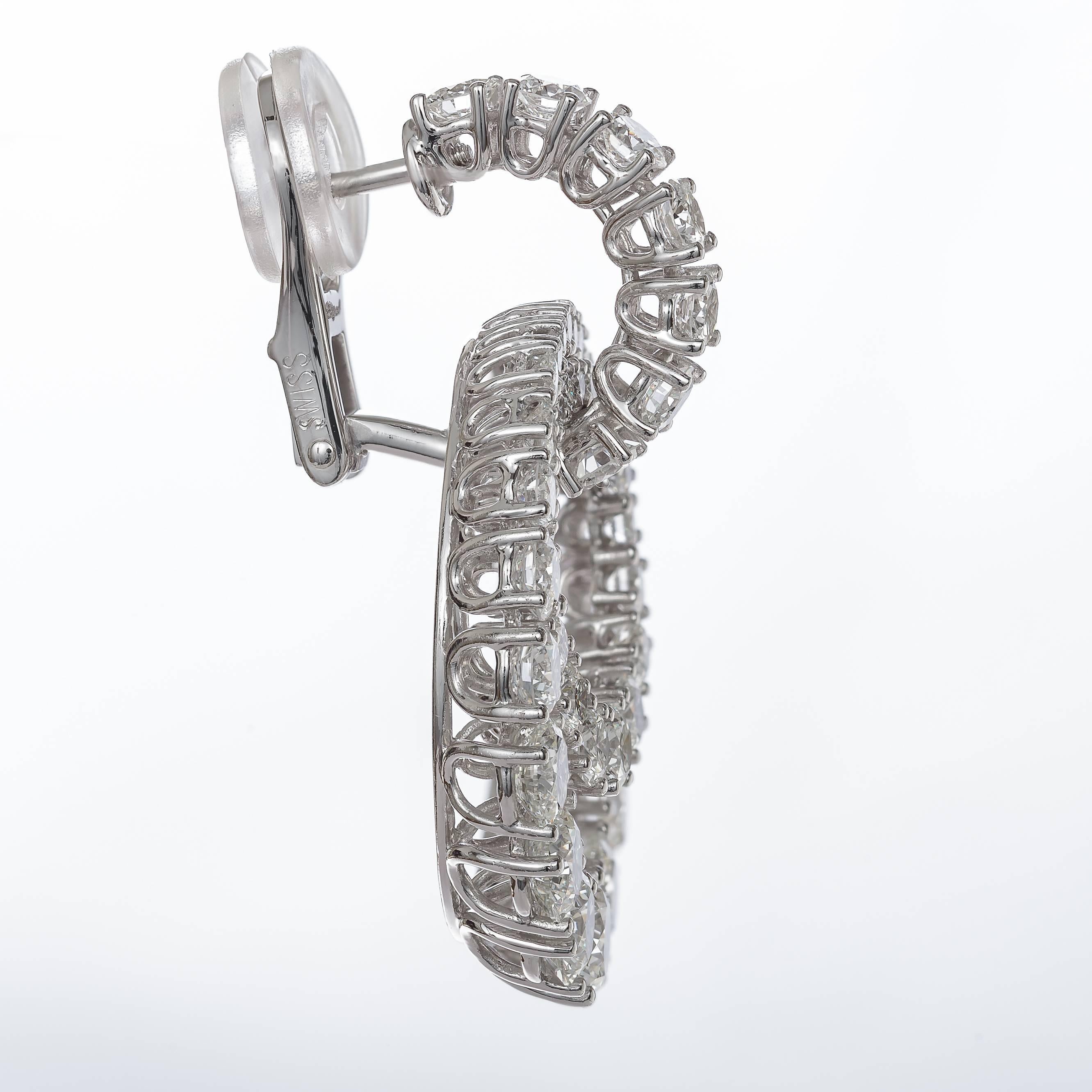 These stunning 18k white gold leverback Chopard earrings for pierced ears are set with 98 round brilliant diamonds in varying sizes, totaling 9.40 carats of  diamonds. Chopard uses F-G color VVS1-VS1 clarity diamonds. The earrings are in excellent