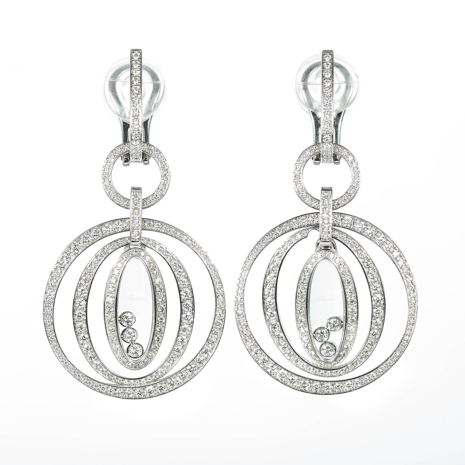 These beautiful 18k white gold earrings have 362 round brilliant pave-set diamonds totaling 2.00 ct. Each earring has three floating diamonds. Chopard uses F-G color VVS1-VS1 clarity diamonds. These earrings have barely been worn and are like new.
