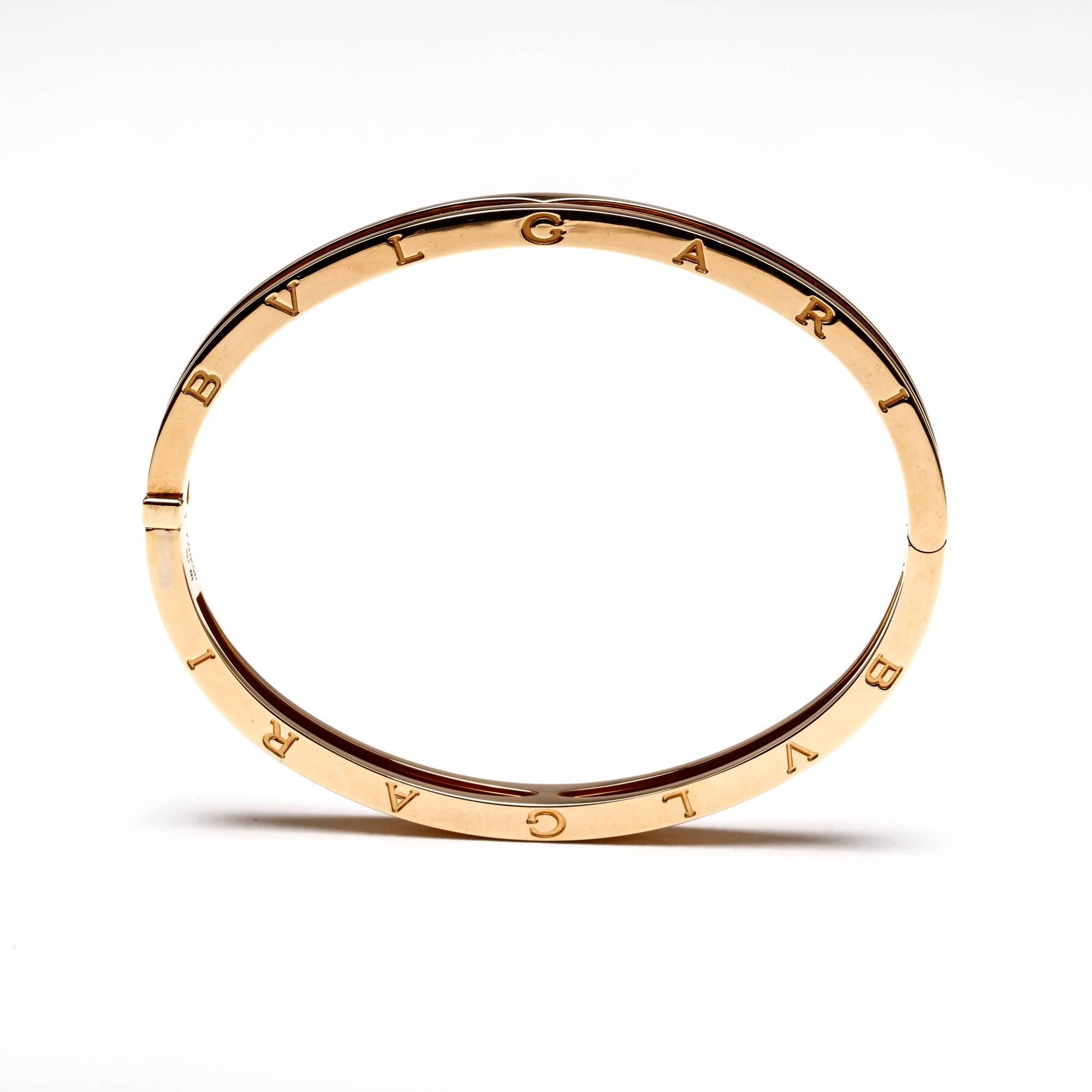 Inspired by the Colosseum in Rome, this 18k yellow gold Bulgari B.zero1 bangle bracelet in size medium represents both the eternal city and modern Italian design. The push-button closure makes for effortless and comfortable removal. This item is in