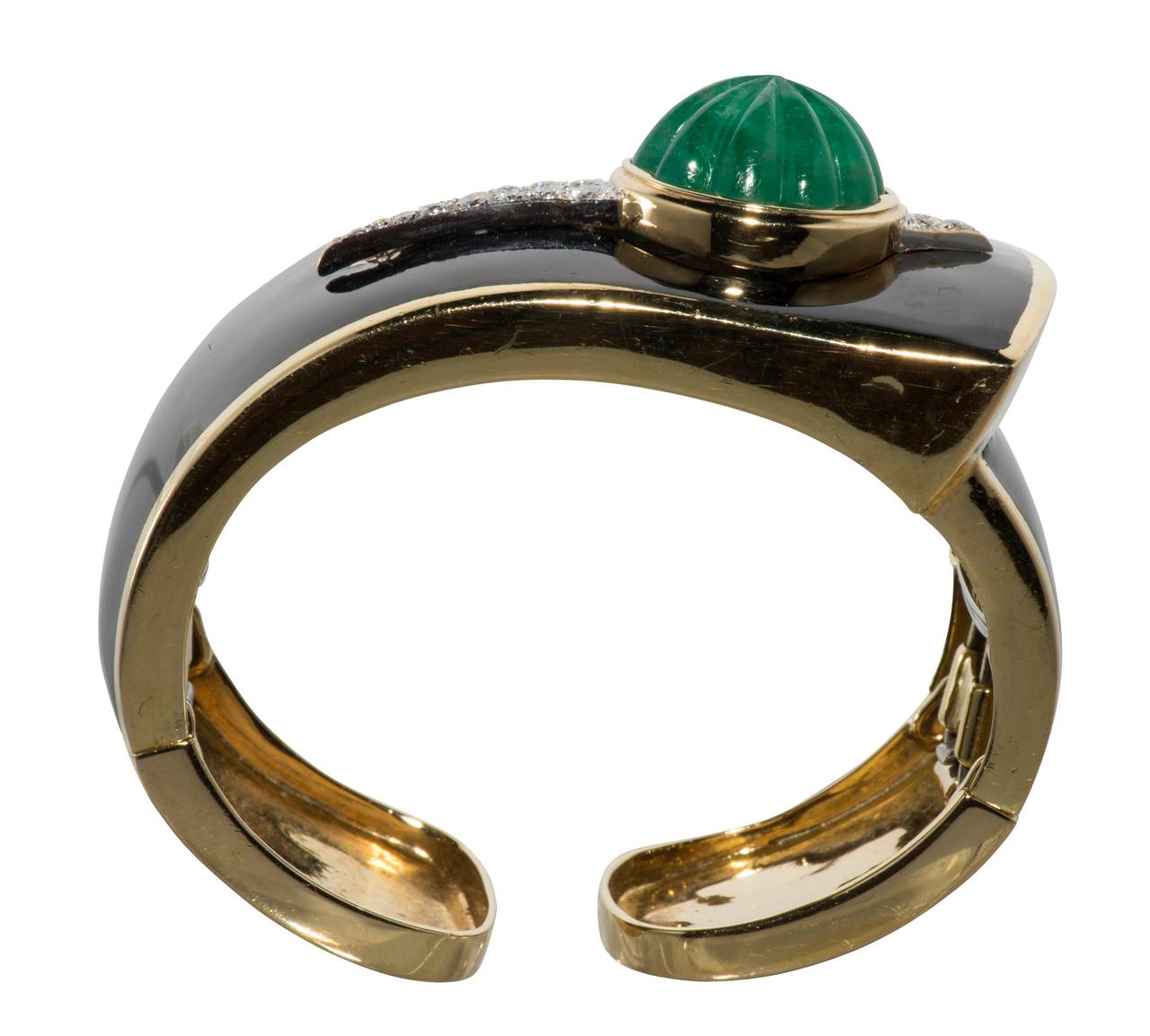 Classic black enamel hinged cuff with a melon carved emerald weighing approximately 10ct.  It is set in yellow gold with diamonds weighing approximately 1ct. set in platinum.