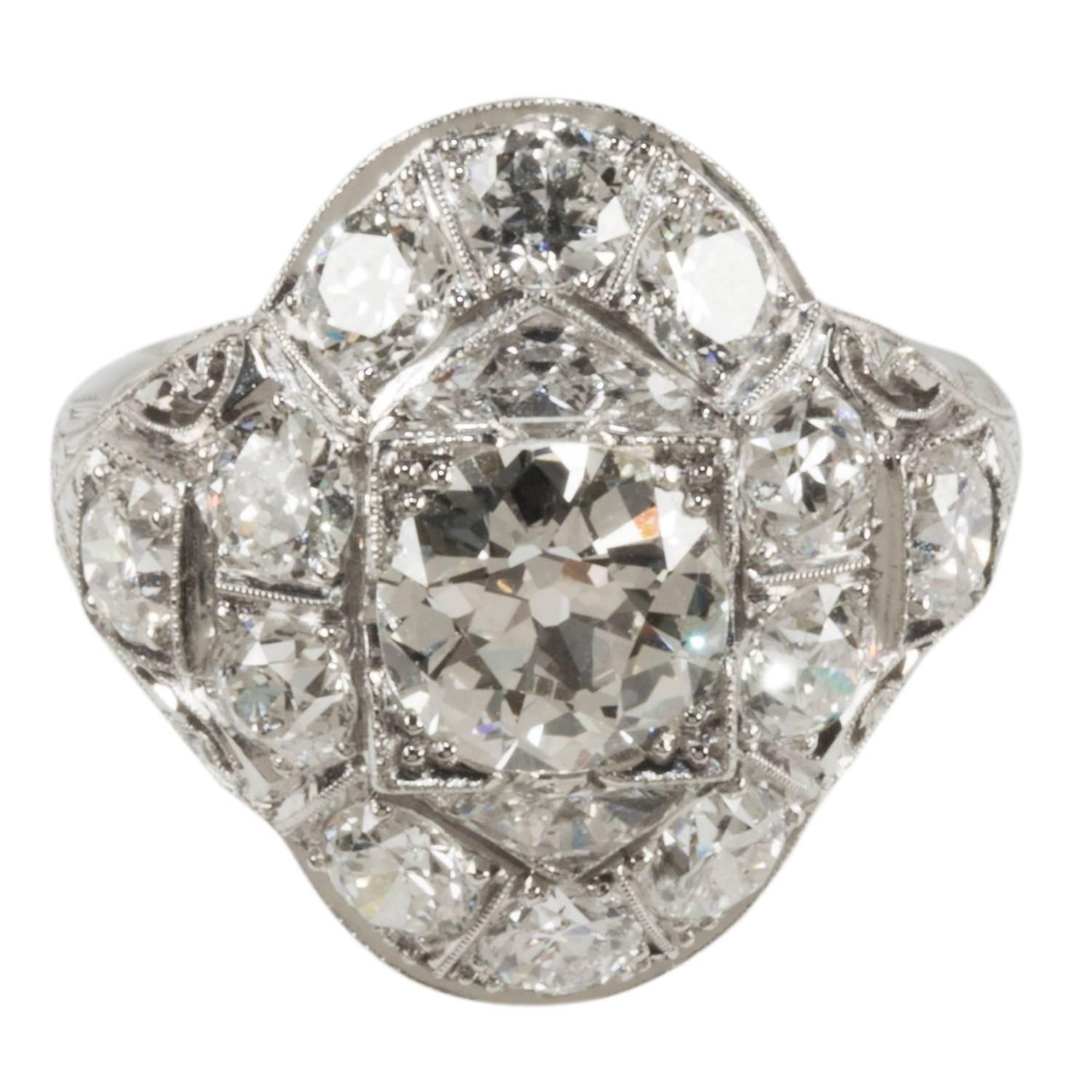 This is a lovely diamond cocktail ring set in platinum.  It is a size 8, but can easily be resized.  The center stone is 1.50cts and the side stones are approximately 2.50cts total weight.