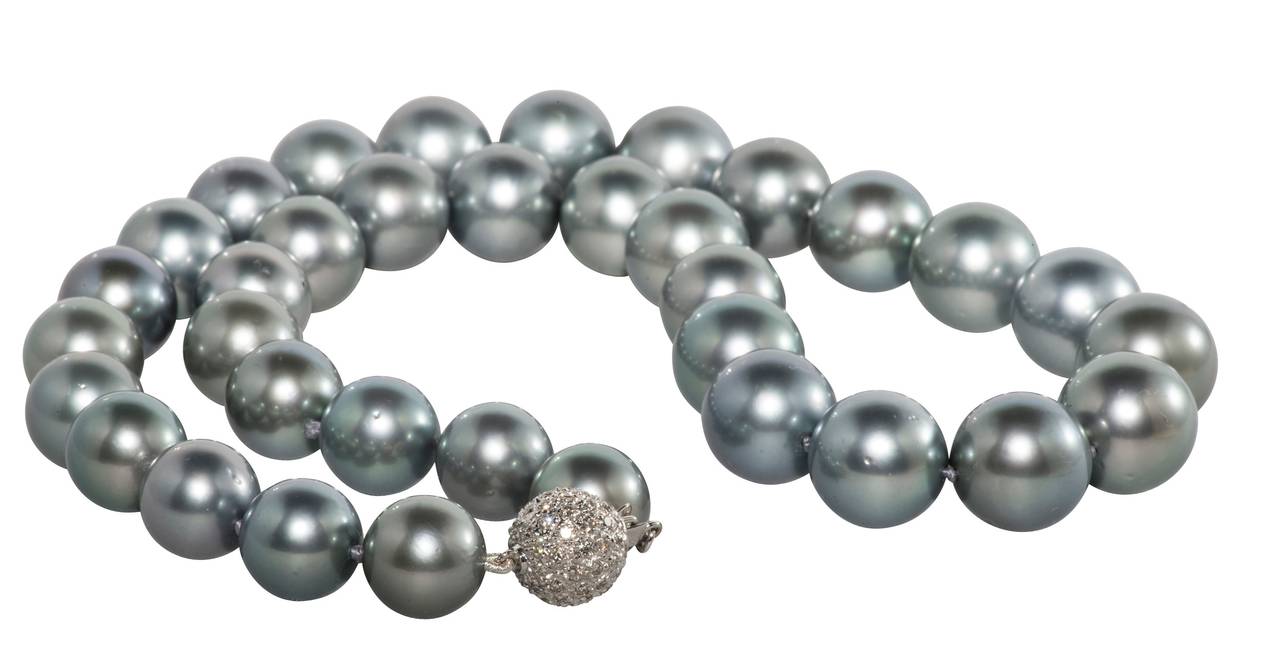Beautiful graduated Tahitian pearl necklace with pearls ranging from 11mm to 13mm in size.  The clasp is a simple but elegant pave diamond ball.