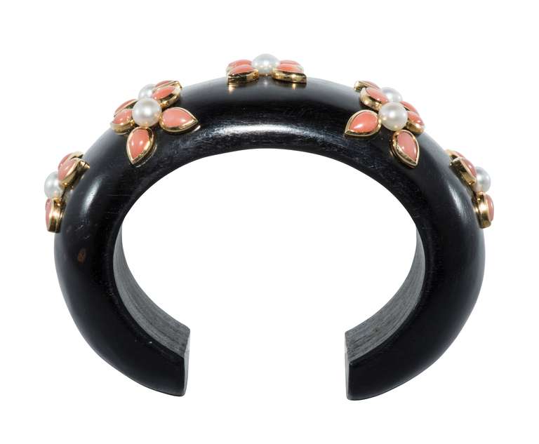 Cuff made of Ebony from 1930 set with natural coral in 18kt gold and pearls.  Limited number of  pieces designed.