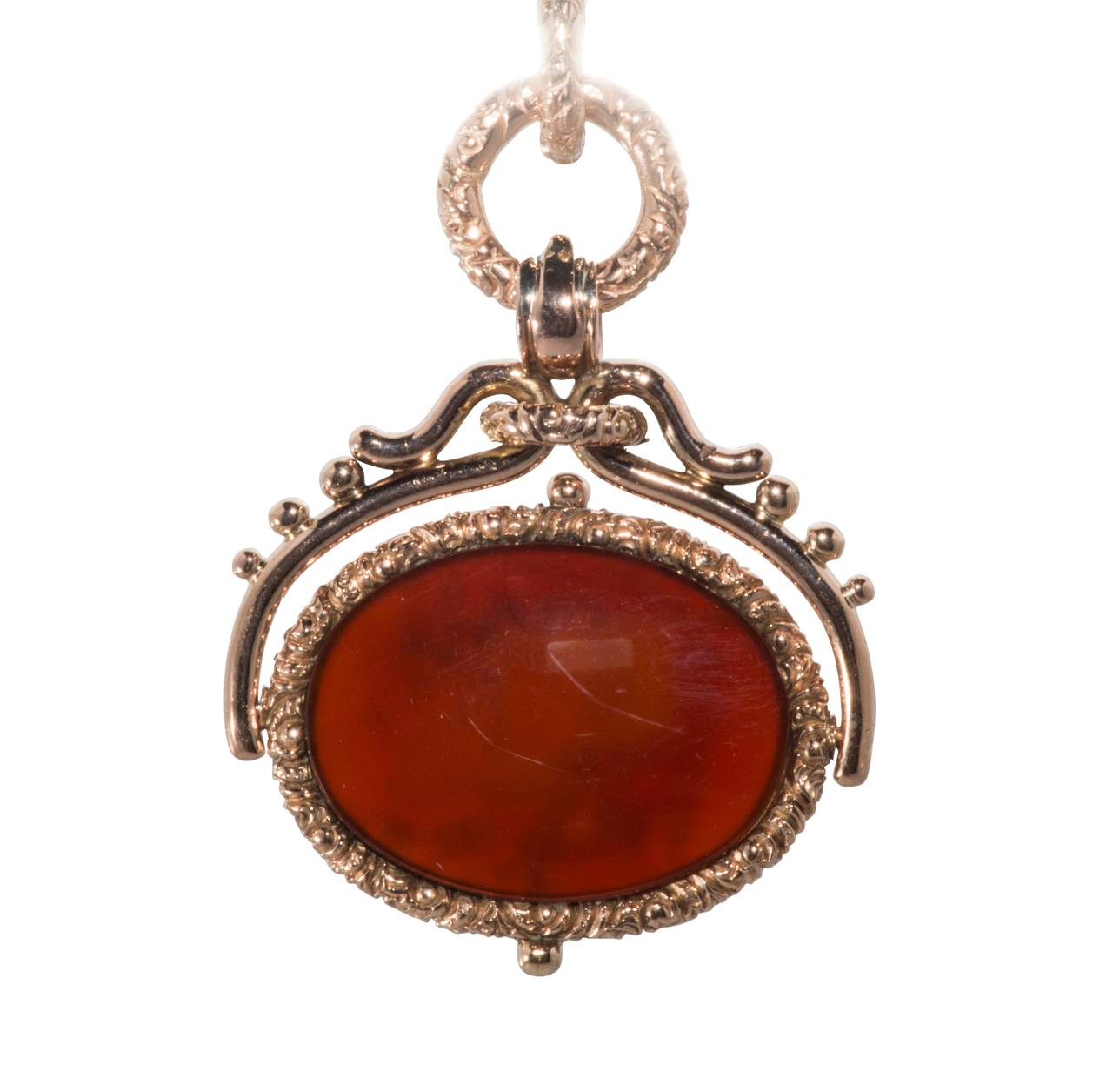This is a very pretty and interesting piece.  It is Etruscan Revival style from the Victorian era.  It is an intricately carved intaglio and is set in rose gold. It was originally a watch fob that has been converted into a pendant.
