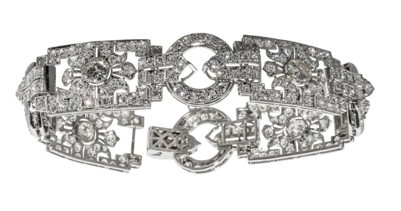 This is a  stunning French Art Deco platinum and diamond plaque bracelet. The four principle stones weigh approximately 1ct. each.