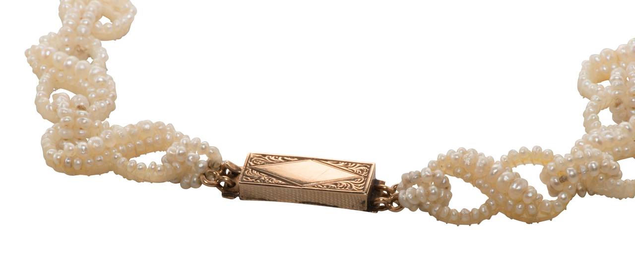 A lovely and intricate beaded natural seed pearl necklace from the Victorian era with a 15k yellow gold clasp.