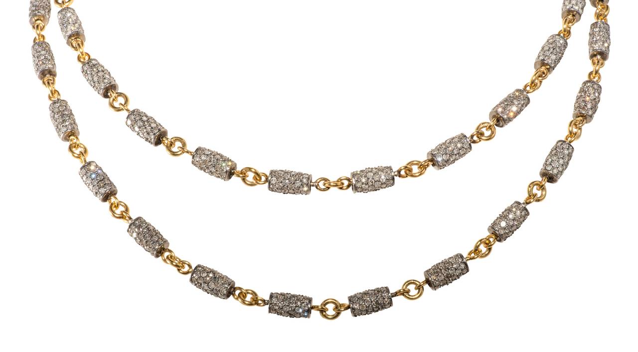 Unusual handmade 18k gold links interspersed with blacken silver barrels paved set with diamonds weighing approximately 20cts.