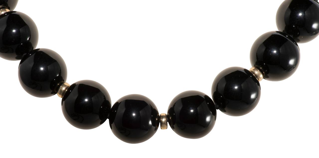 20 mm Black onyx bead necklace with 14k spacers and 14k and black onyx clasp. 18 inches long.