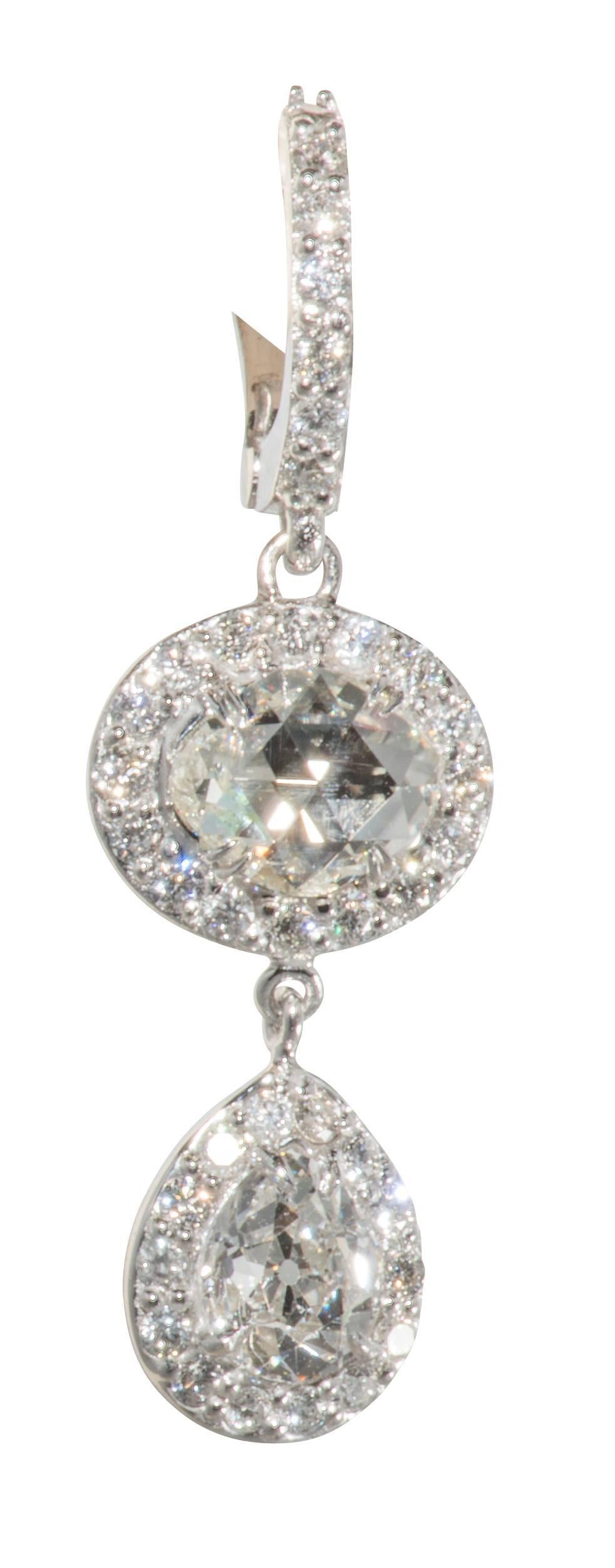 These are stunning diamond drop earrings all set in platinum.  The rose cut diamonds are 2.38 tcw , the pear cut diamonds are 2 tcw and the melee is approximately 1.32 tcw.  The oval shape diamonds and the pear shaped diamonds are all antique cuts. 