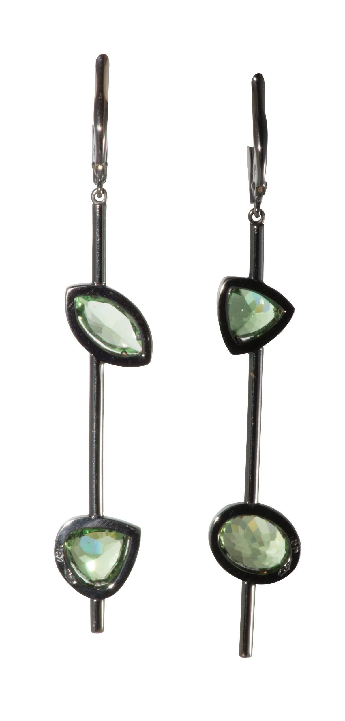 These are striking diamond and demantoid garnet drop earrings set in blackened 18k white gold.