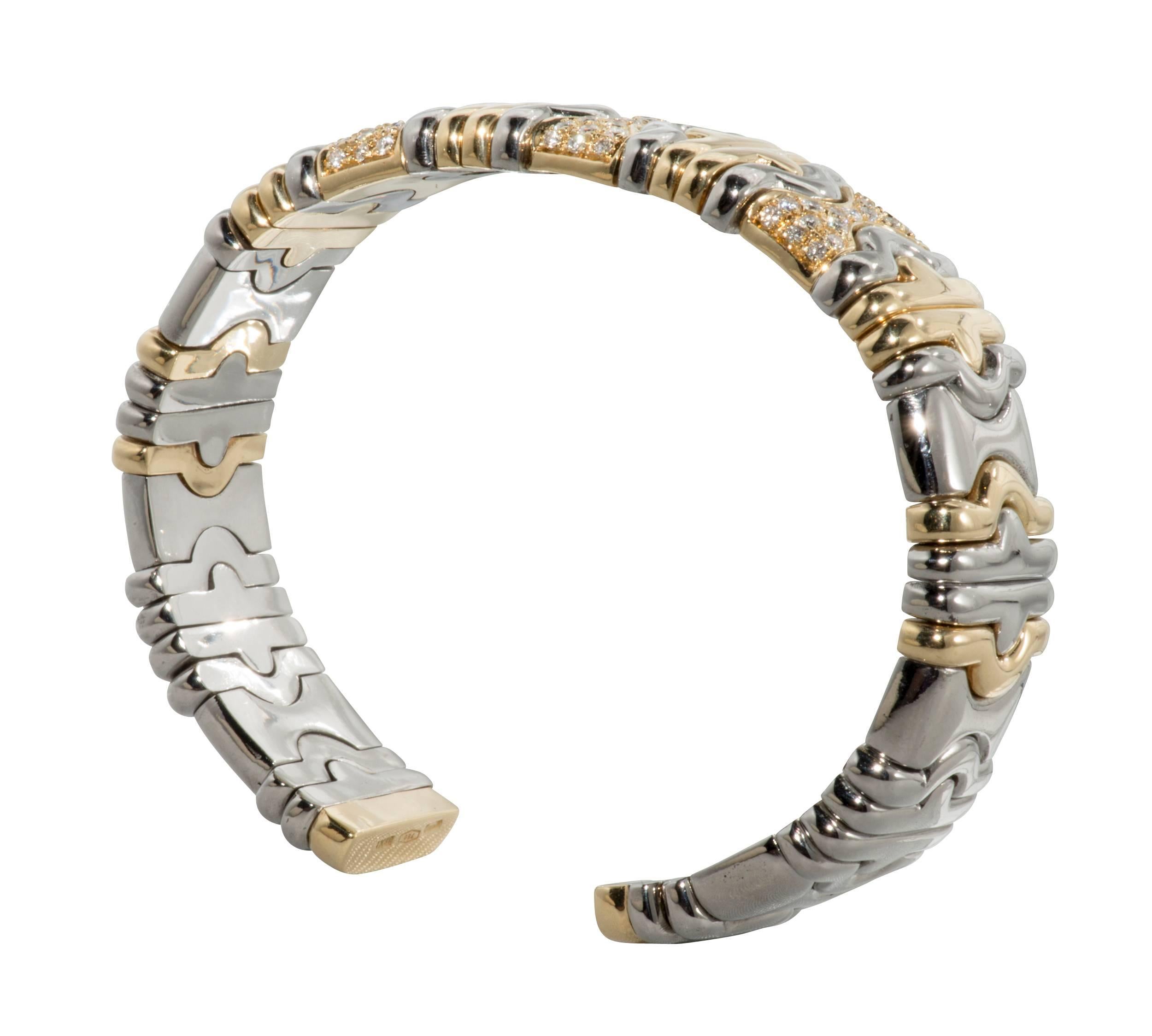 This cuff is Bulgari style of 18k yellow gold and stainless steel with diamonds.