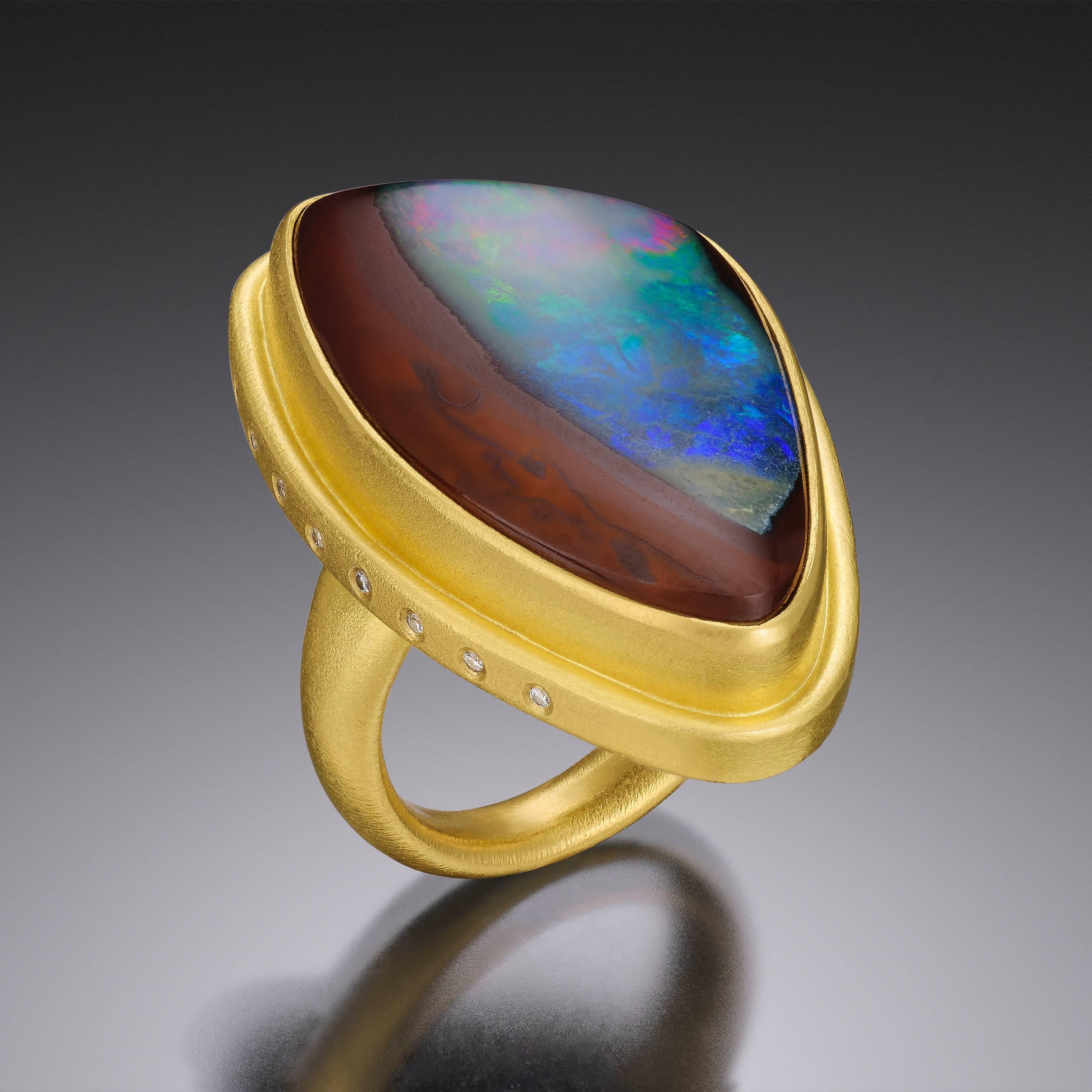 Handmade 22kt yellow Gold band set with Australian rainbow Boulder Opal and eight Fvs white Diamonds. 

* Each piece is designed and crafted entirely by hand in the traditional way, using age old techniques and processes.