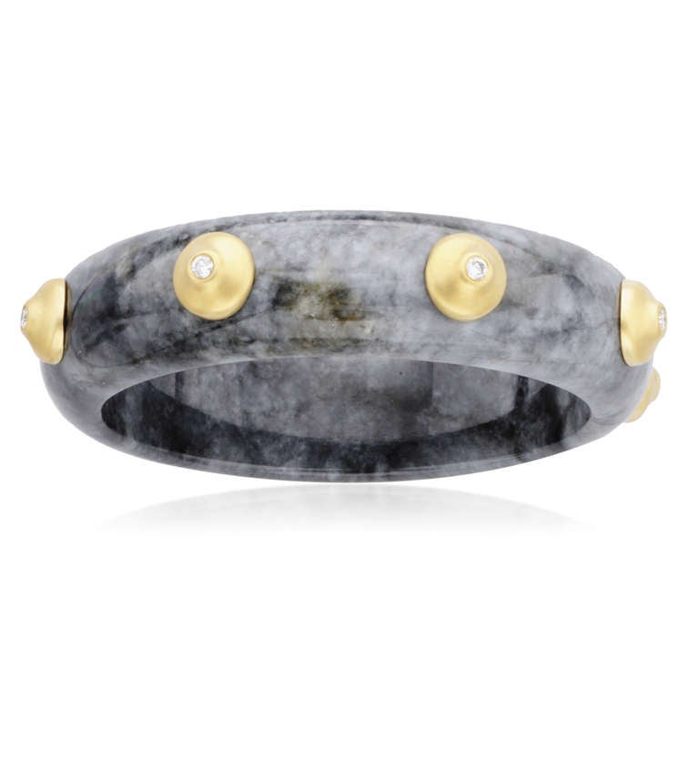 This Donald Huber Large Dark Gray Jade Diamond Bangle features eight 18k yellow gold stations each accented with a diamond totaling .67 total carat weight. The bangle was handmade in our New York salon and signed by the designer.