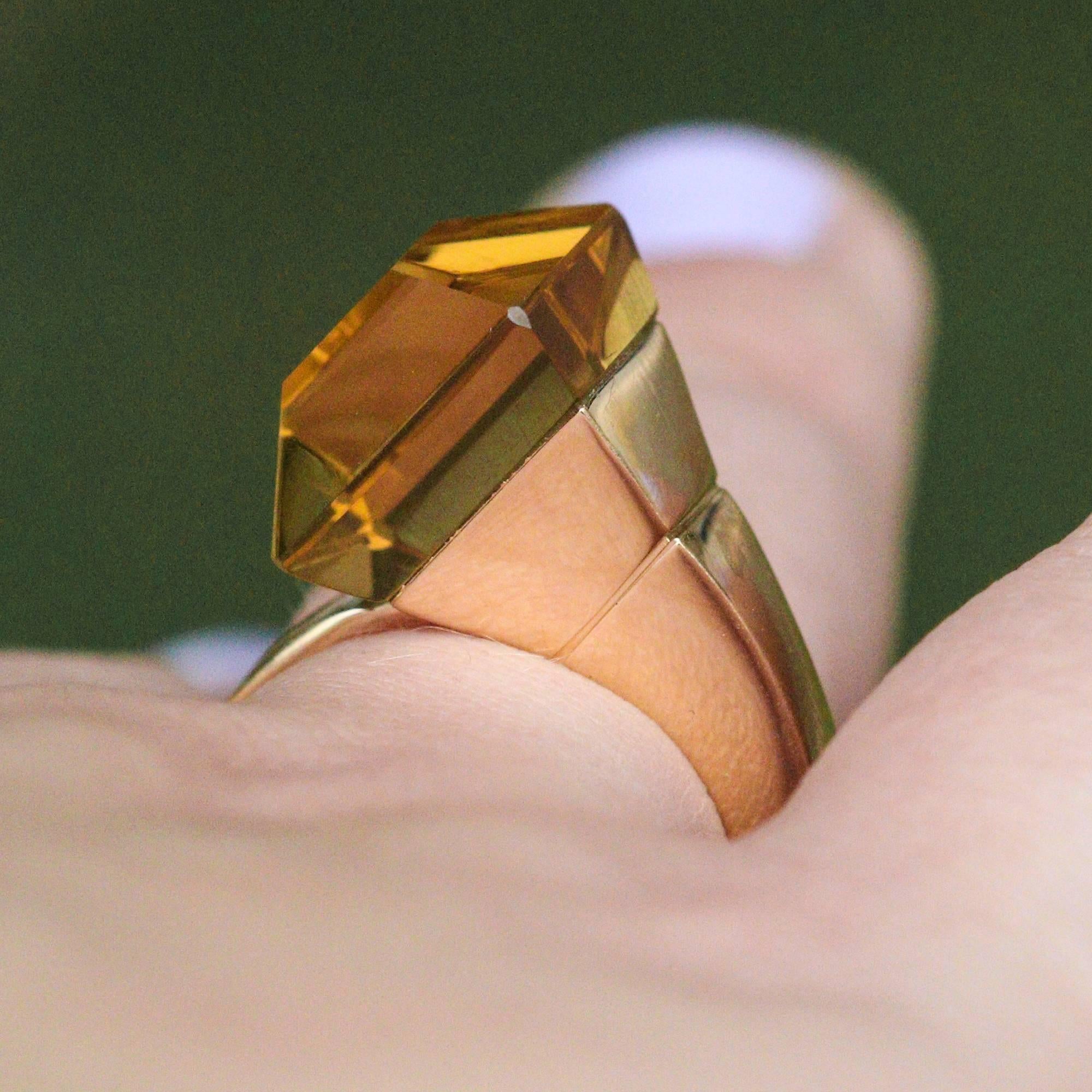 This beautiful and unique Chiodo ring by Gucci features a 12 x 12mm step cut citrine set asymmetrically at the top of the ring. The stone is set in a very unique way that provides mystery in regard to how the stone is held in place. The setting is