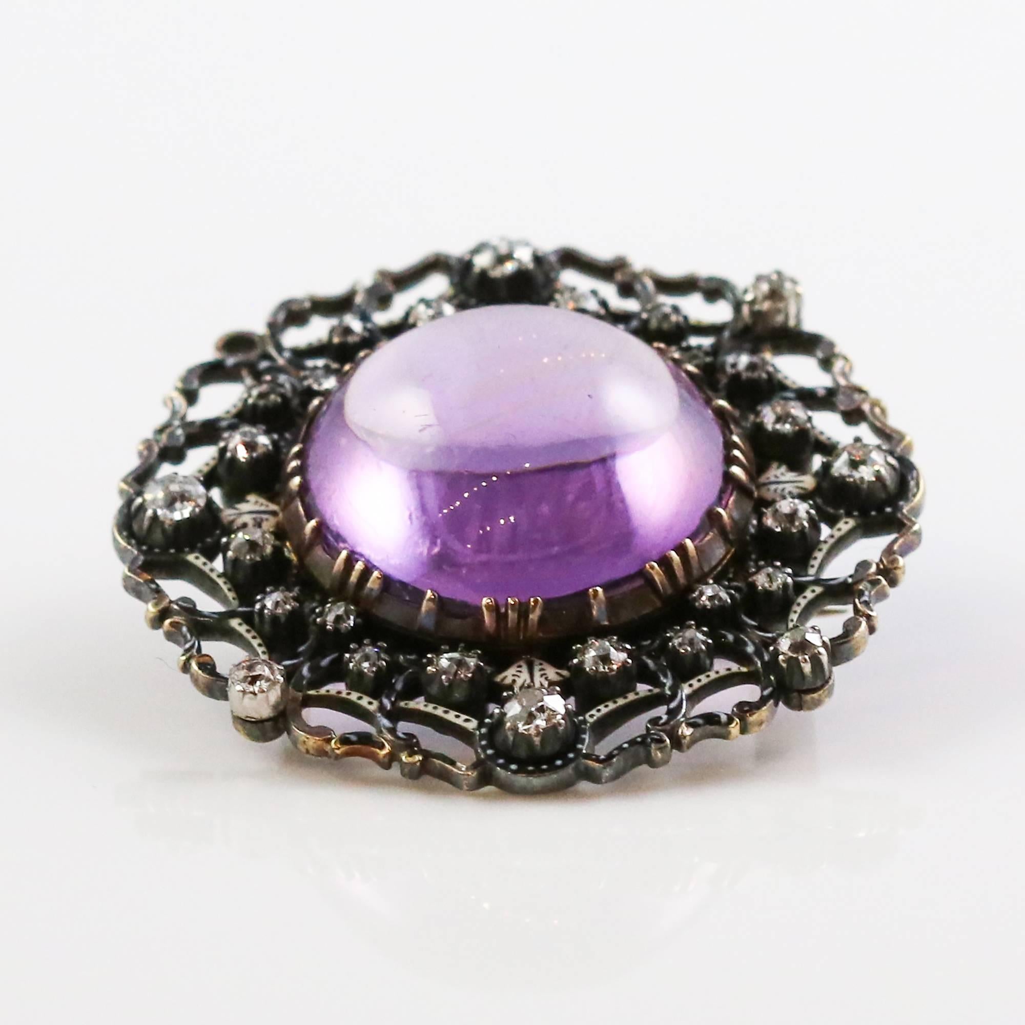 This stunning brooch is in remarkable condition considering it is over 200 years old. The center stone is a hypnotic 18mm cabochon cut amethyst set in 18k yellow gold with a sterling silver top. Much of the silver is heavily tarnished, which gives