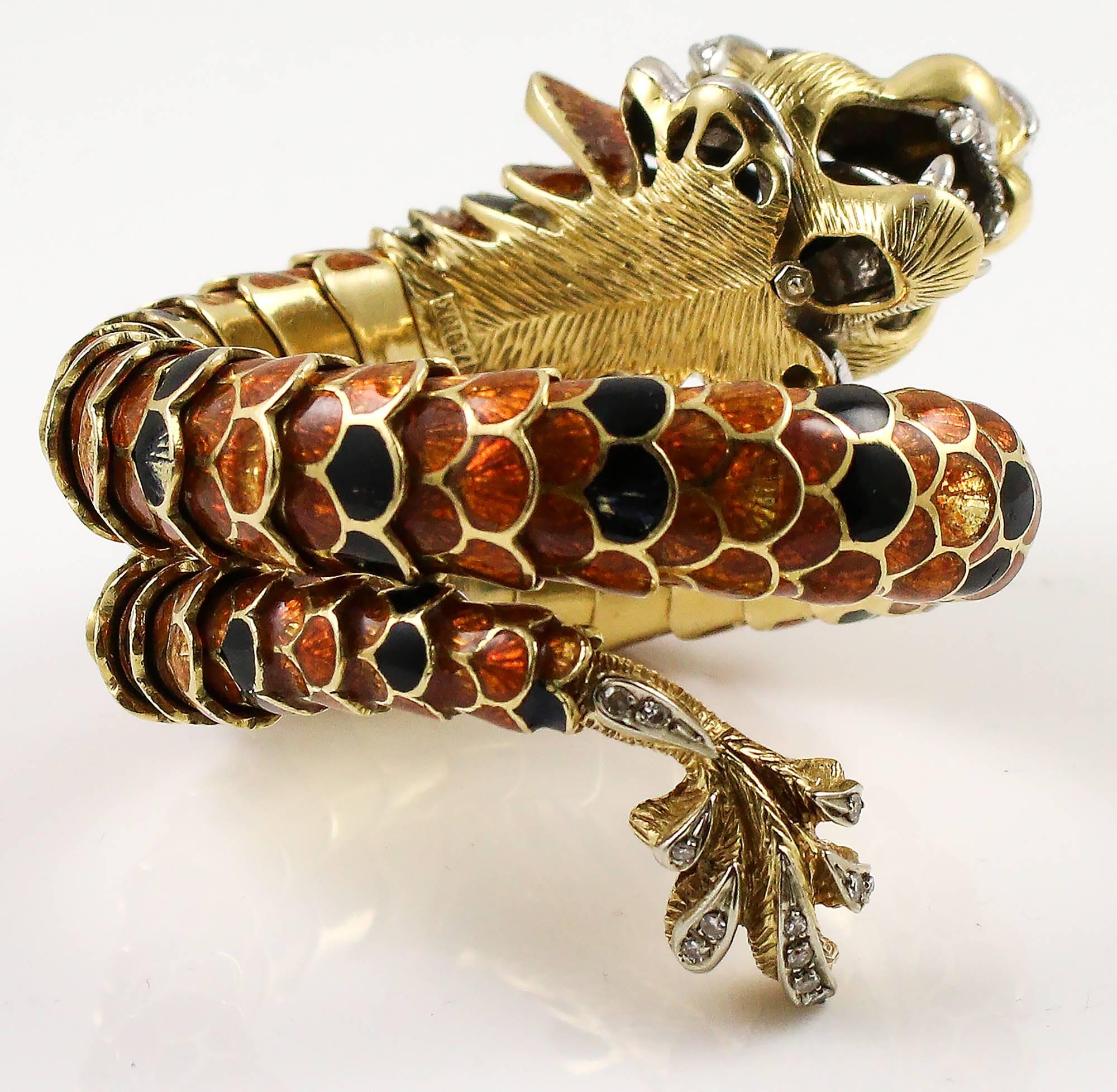 This remarkable piece is made with 18k yellow gold with hand painted orange and black enamel, diamonds and 2 marquise cut rubies for eyes. The teeth and tongue are platinum and the diamonds are set in a platinum base on top of the yellow gold. The
