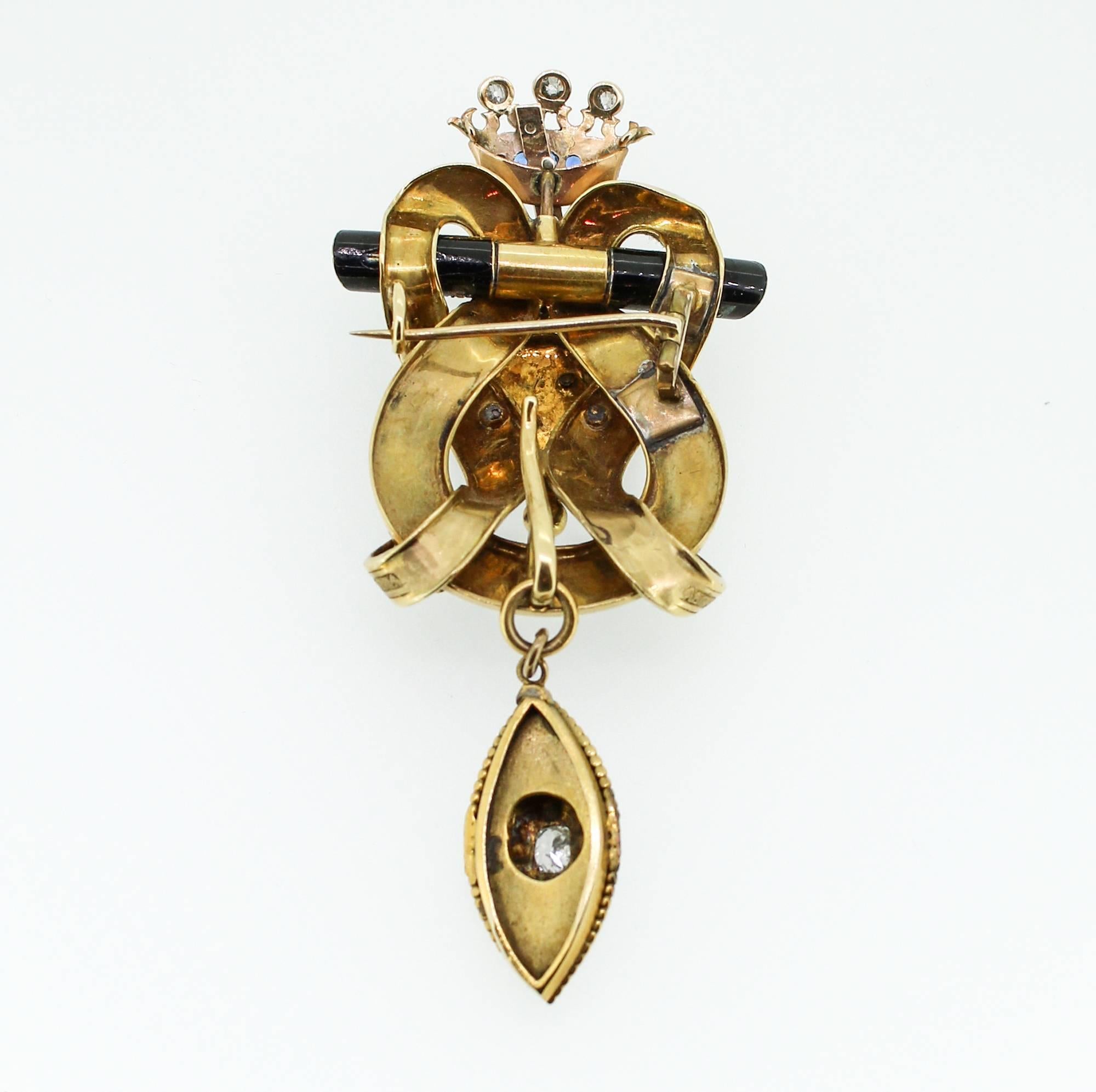 This antique, late Georgian yellow gold and enamel brooch contains 32 primitive cut diamonds (rose cut and old cushion cut), estimated to weigh a total of 1.25 carats. The crown at the top of the pin also contains 5 very clean and vibrant synthetic