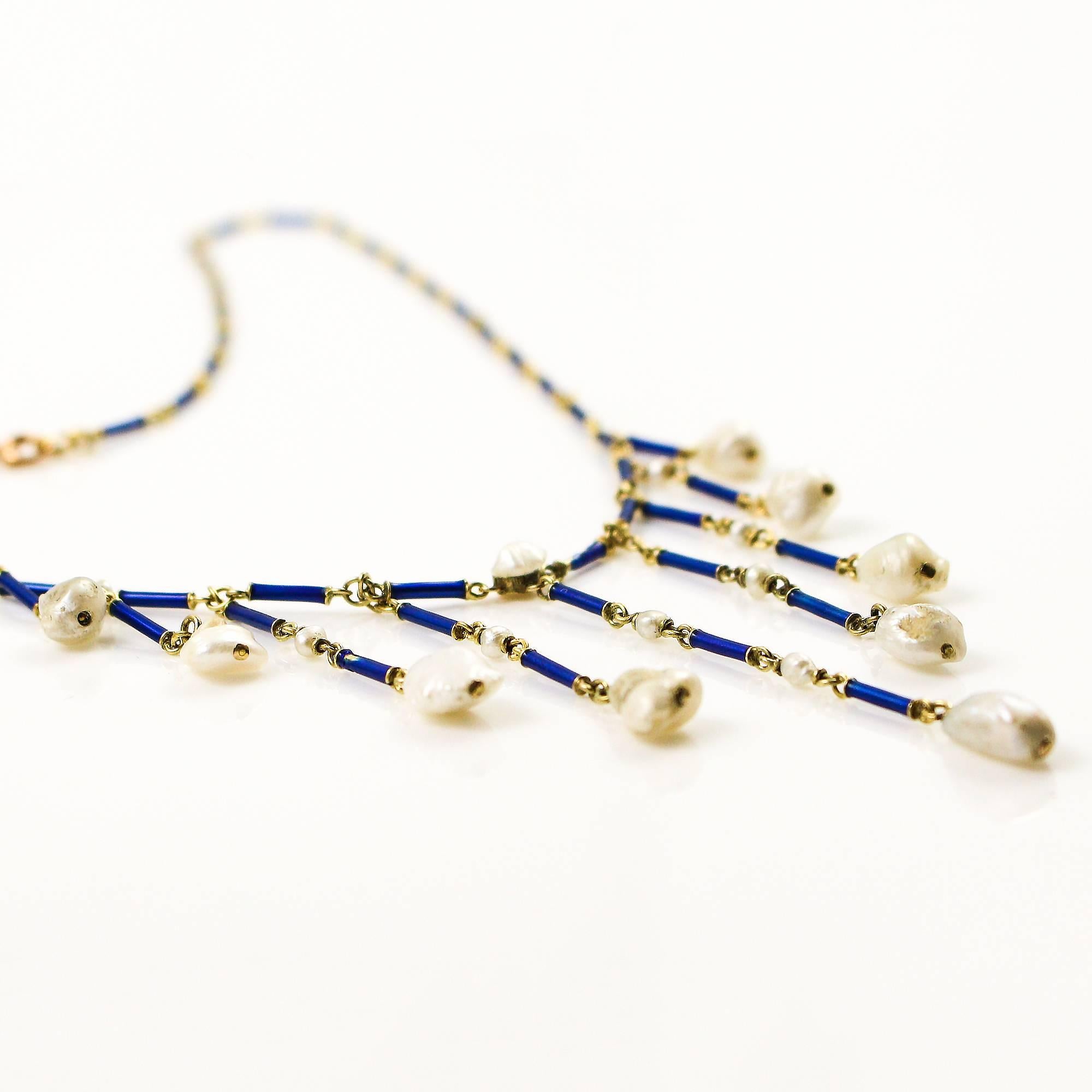 This beautiful drape-style necklace is constructed with 14k yellow gold and with blue enamel links going all the way around and 18 natural Biwa pearls. The enamel is in near perfect condition showing no noticeable signs of wear. The necklace is 18