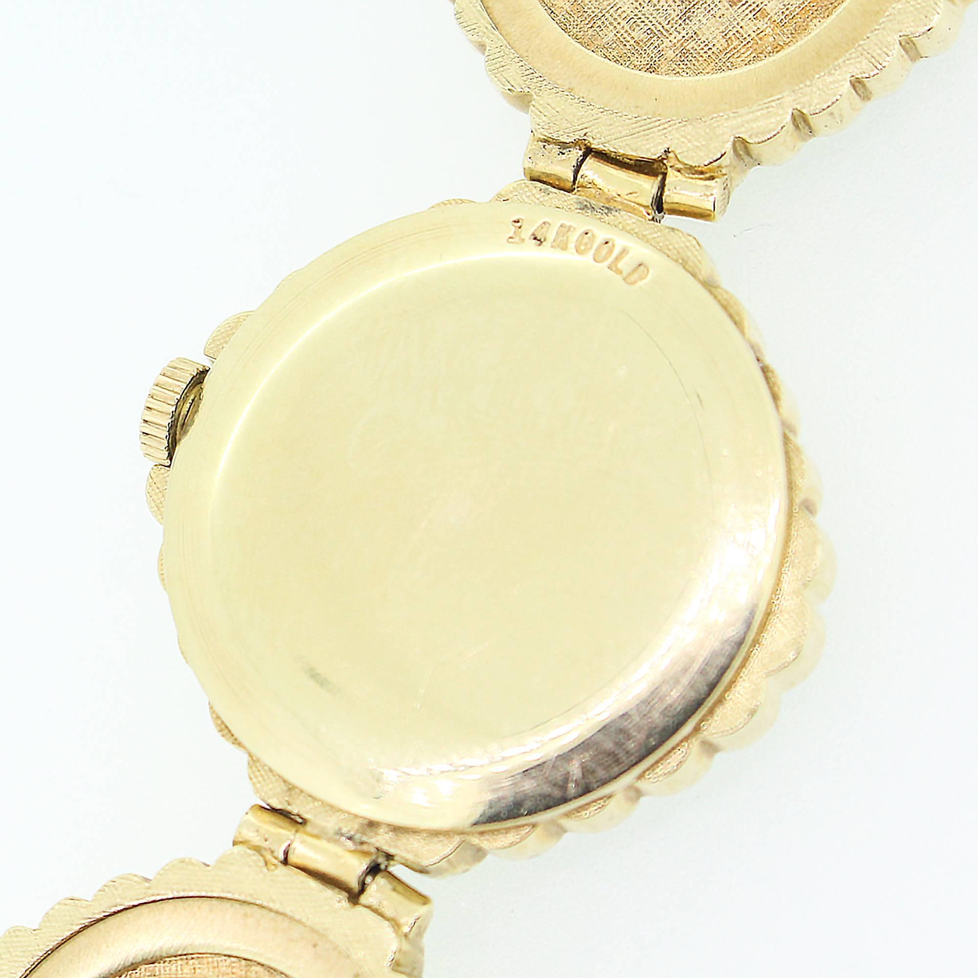 This vintage wrist watch features 8 links and a dial created with a very unique opal mosaic design. The watch is 14k gold with a serial number indicating it was created in 1972. The watch includes a 17 jewel manual wind movement.