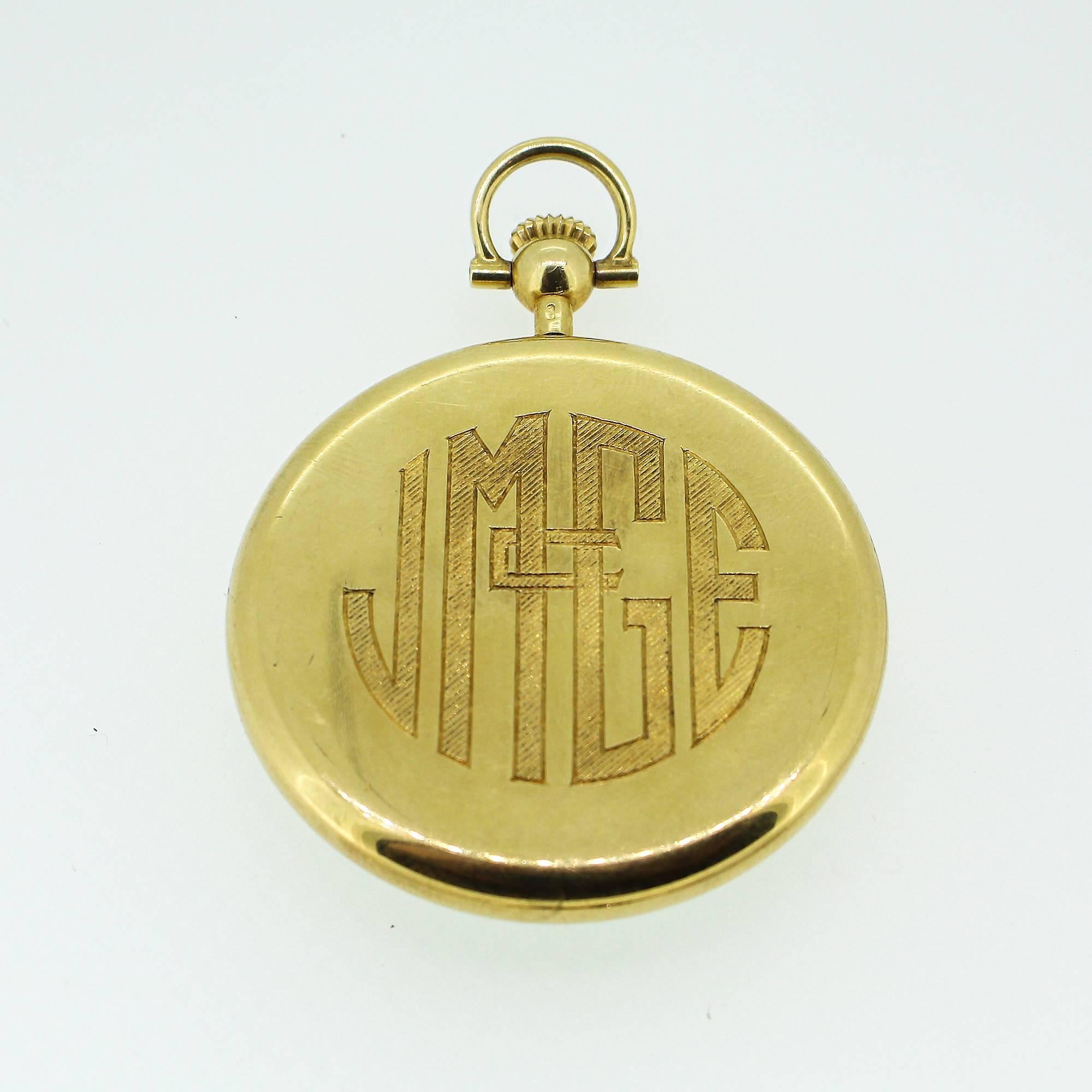 A vintage Tiffany & Co pocket watch in 18k yellow gold with a white face and gold numerals. The watch appears to be working and is in excellent condition, and the back is monogrammed. The 17 jewel movement and case is signed 