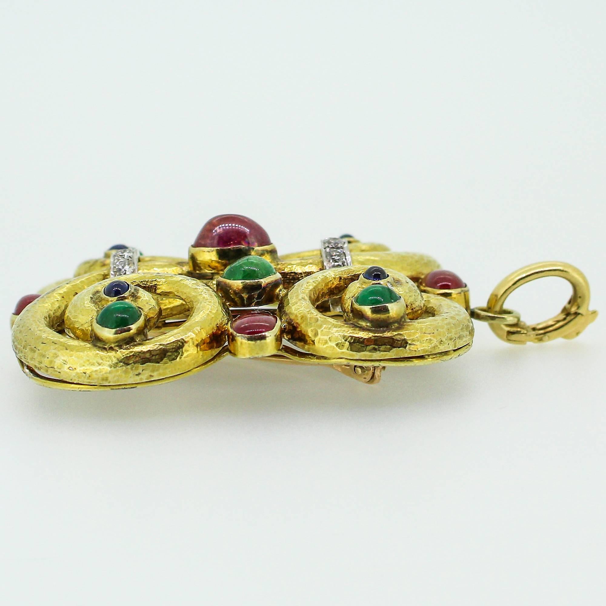 This phenomenal pendant/brooch gives is a perfect product of the 1960s-70s. With it's hammered, yellow gold finish and colorful cabochon precious gemstones, it allows the wearer many different options. It can be worn as a brooch or the removable