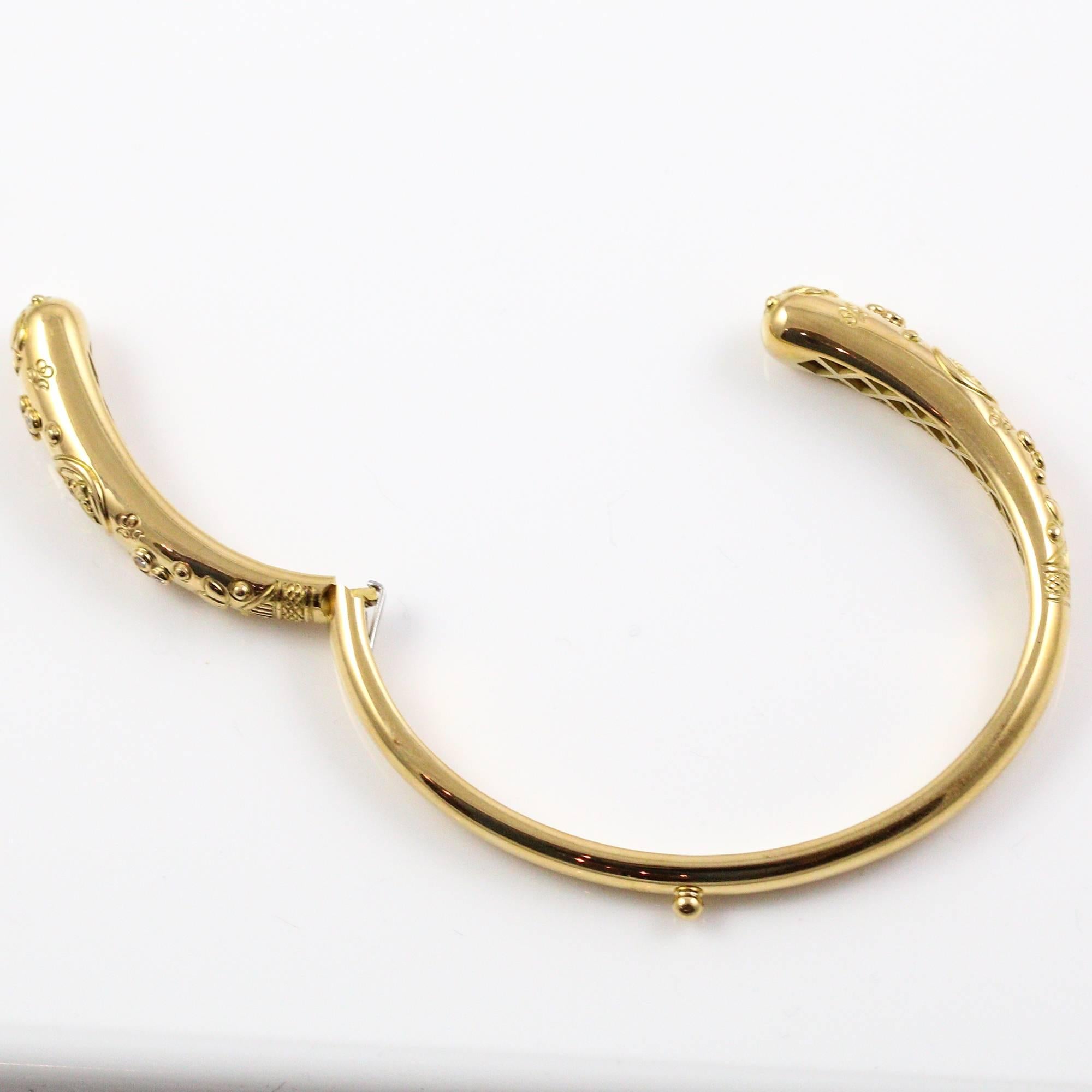 This Temple St. Clair Nomad Bella bangle bracelet features a unique engraved design and 12 round diamonds on the outside, with Temple St. Clair's signature 3 diamond design on the inside of the bracelet as well. It is hinged on one side so that it