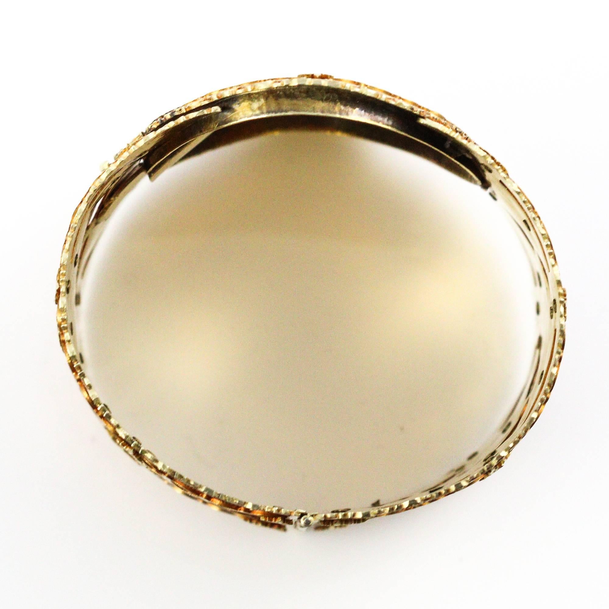 This 14k yellow gold Etruscan style wide bangle bracelet best dates back to 1890-1910. The bracelet is 52mm wide around the outside and 62mm wide at the oval portion in the very center. The craftsmanship and detail work on the bracelet is truly