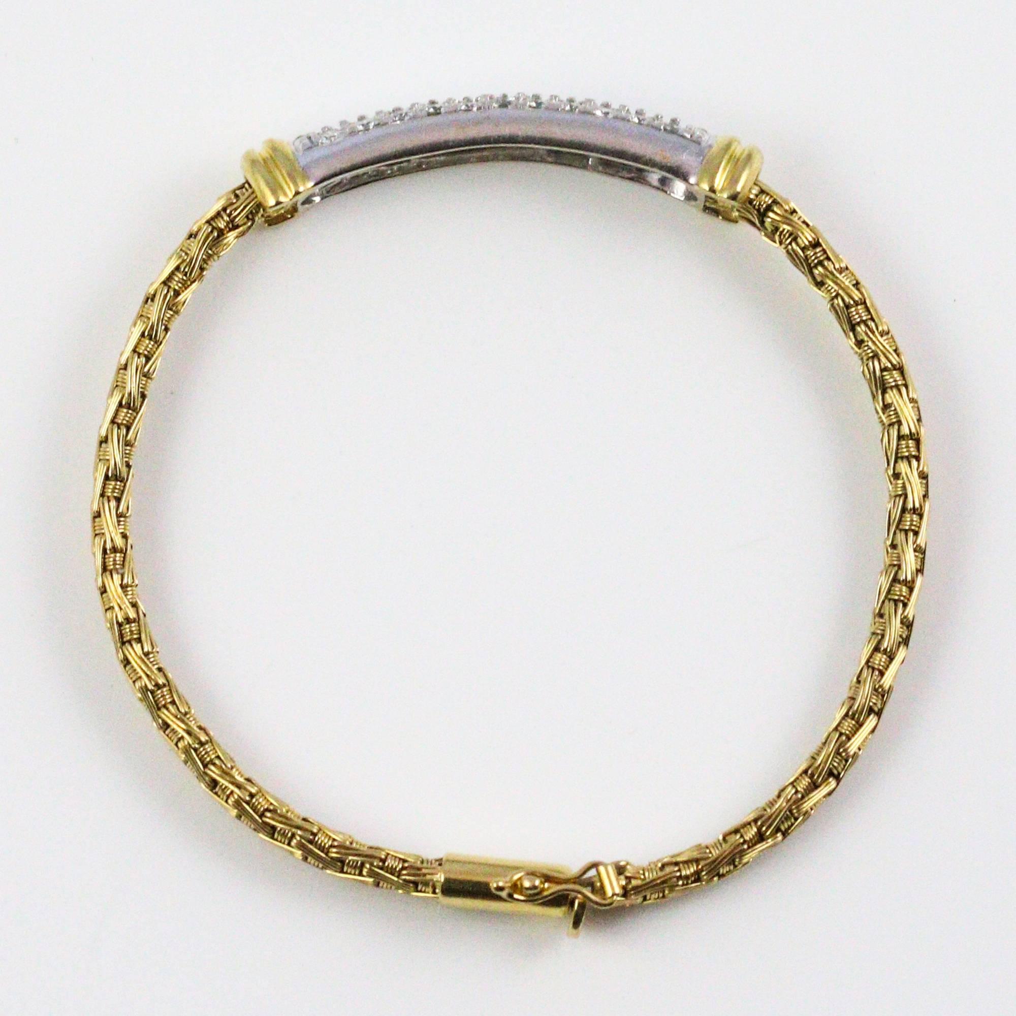 This gorgeous bracelet features a woven design of 18k yellow gold topped with 34 pave set diamonds, backed in white gold weighing a total of 1.46ctw and grading as "F-G" in color and "VS1-2" in clarity. Next to the hallmarks on