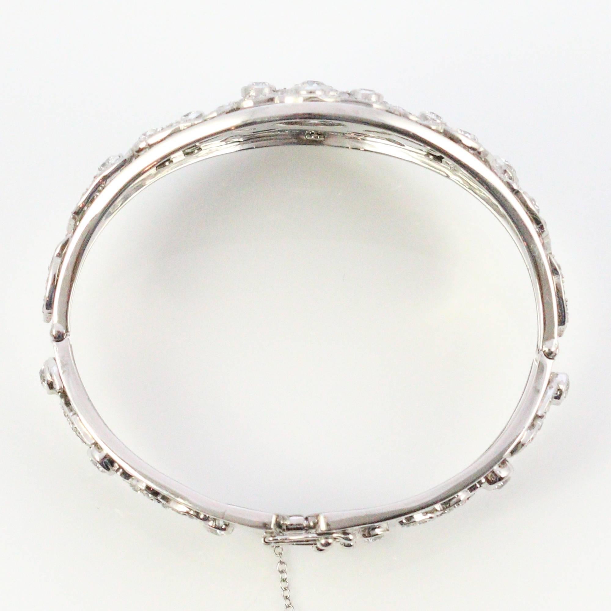 New meets old in this spectacular bangle bracelet! This piece was clearly crafted by a highly trained master jeweler who repurposed Edwardian garland and mounted it onto a modern bangle. The detail work on this piece is nothing short of exquisite!