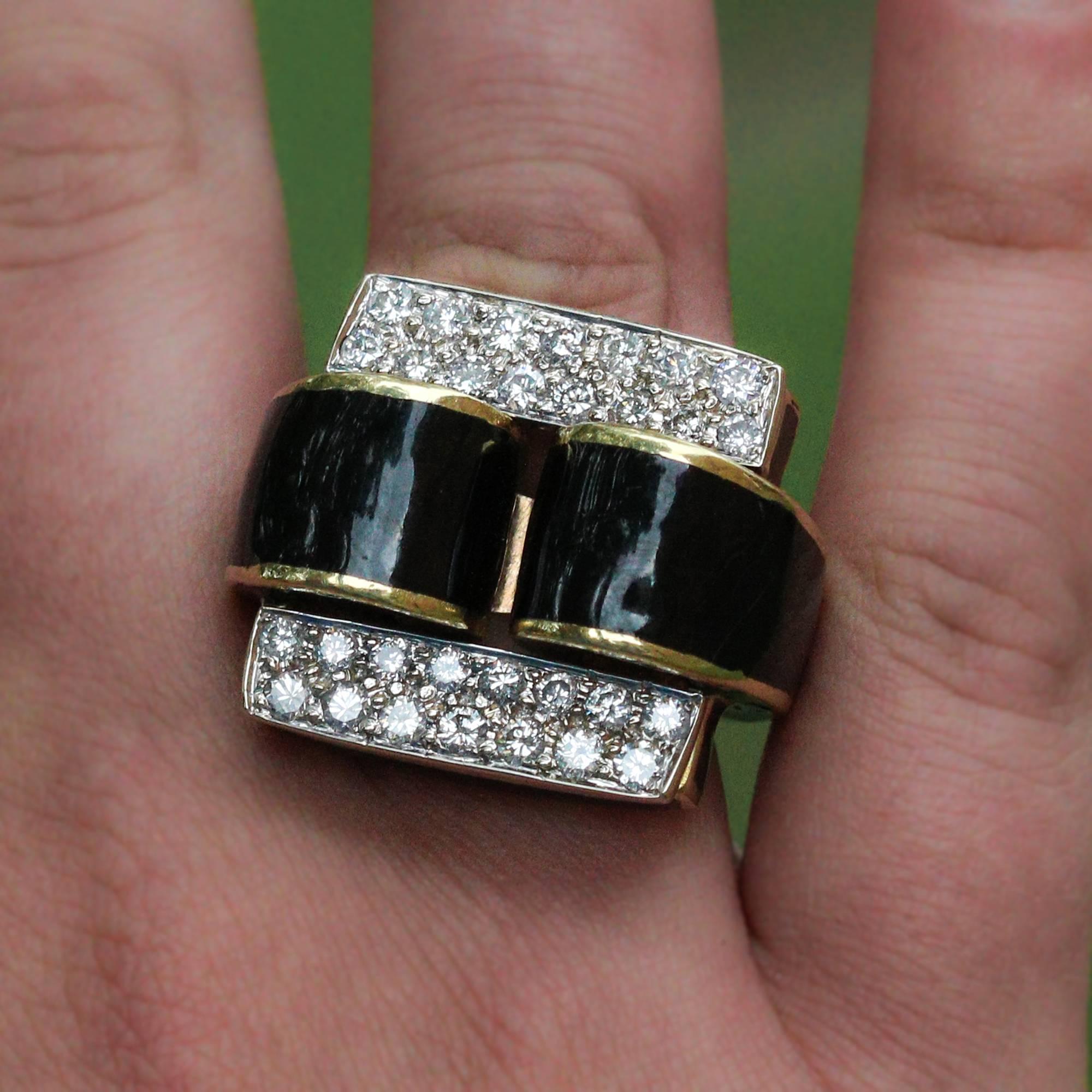 This beautiful ring is made in 18k yellow gold with w hite gold behind the diamonds. The main focus is a unique black enamel design and 30 round brilliant cut diamonds, which weigh an approximate total of 1.40ctw and grade as H-I in color and