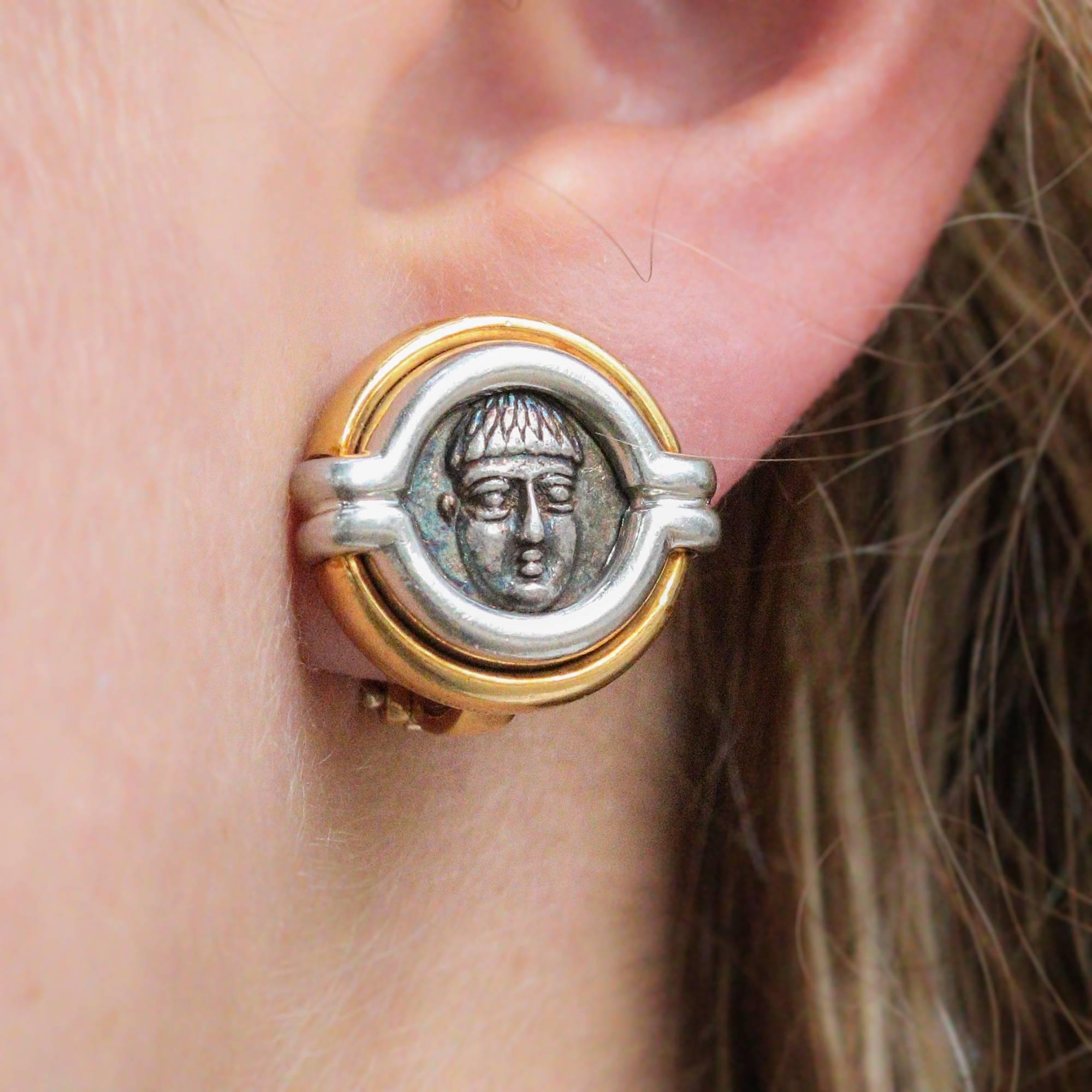 These beautiful earrings feature 2 authentic ancient silver coins dating to the 4th Century BC to the area of Campania, Phistelia, in modern day Italy. The earrings feature a 2 tone casing design with 18k white and yellow gold and a pierced back