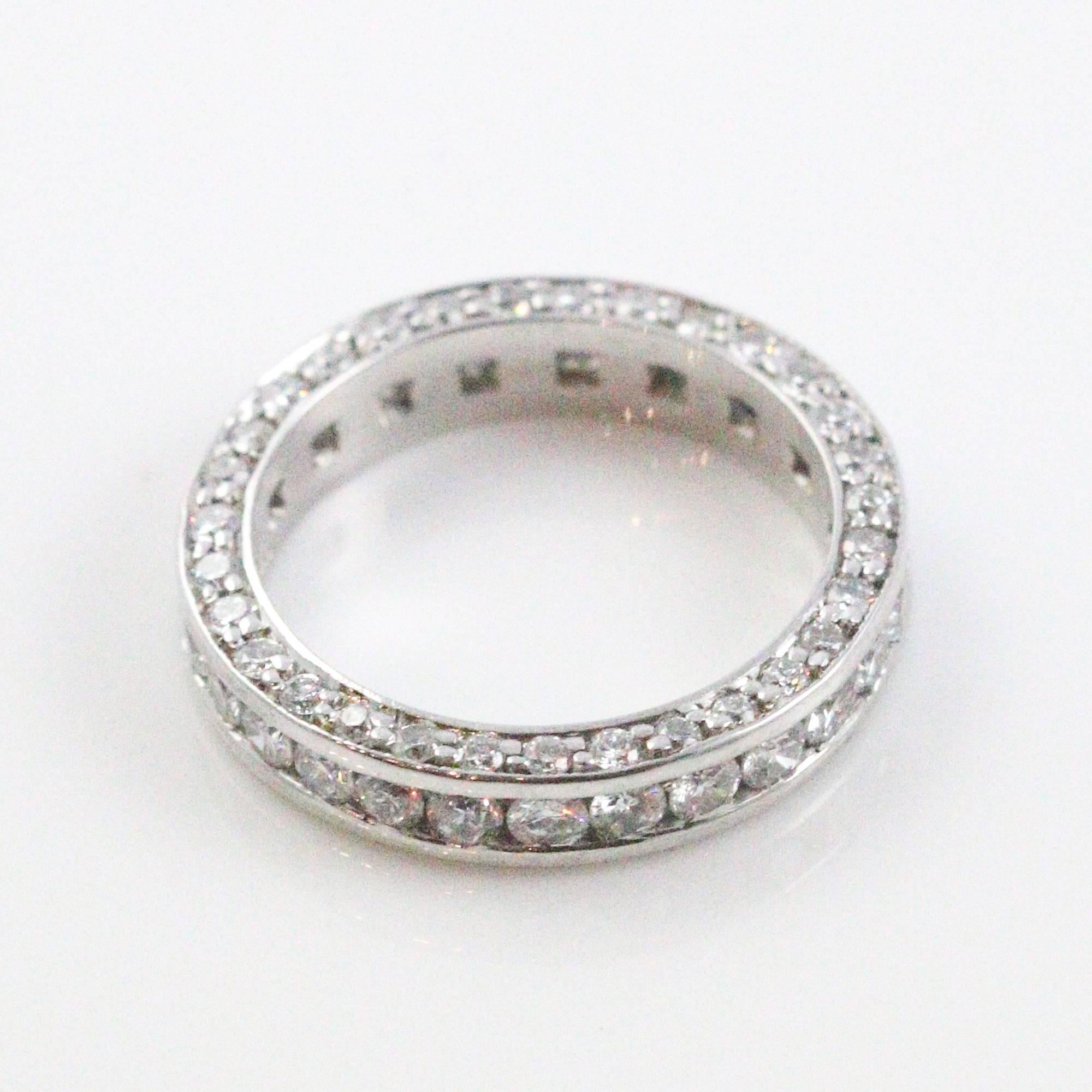 This magnifient eternity band features diamonds on all 3 sides, with channel set round diamonds facing upwards and prong set diamonds lining both sides of the profile. The band features a total of 90 round diamonds, which weigh a combined total of