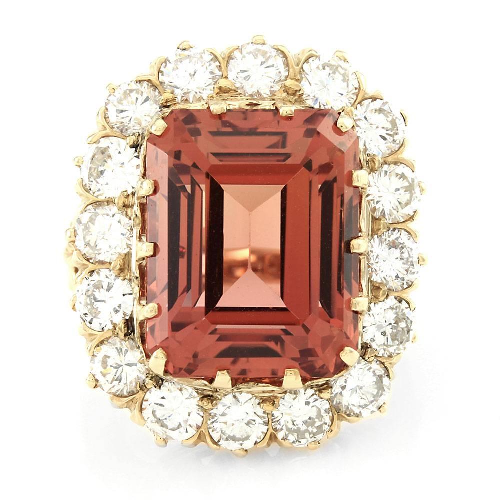 Vintage handcrafted precious sherry topaz and diamond halo ring set in 14K yellow gold. There are one emerald cut topaz (20.36ct) and sixteen diamonds (2.72ctw) with a color of G-H and a clarity of SI. The topaz is claw prong set, and the diamonds