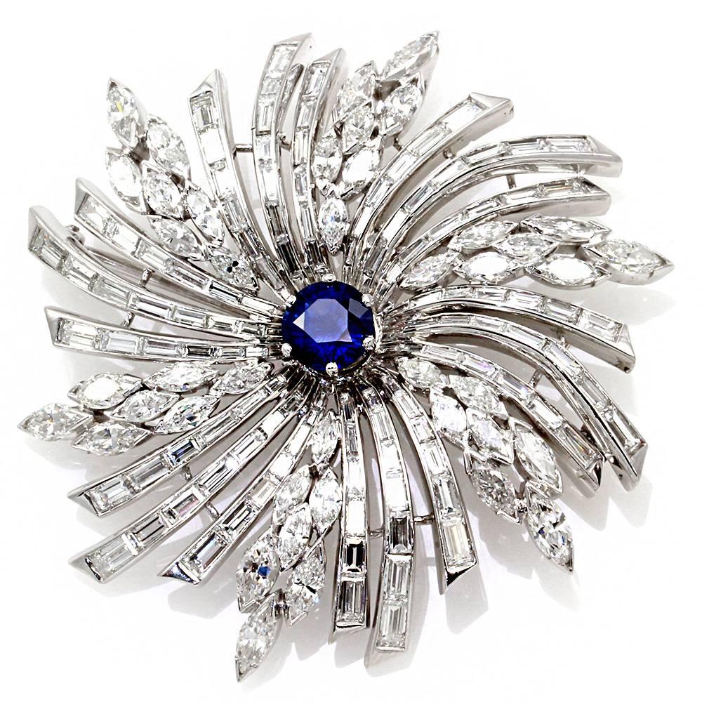 Vintage diamond starburst pin/ brooch/ pendant with genuine sapphire in high polished platinum. There are one round faceted cut genuine sapphire (1.95ct), forty-two marquise cut diamonds (6.72ctw), and ninety-six baguette cut diamonds (7.56ctw) with