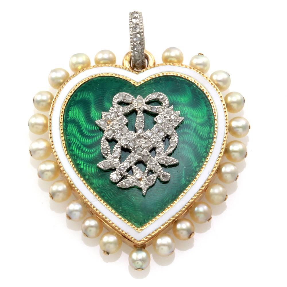 Antique signed designer Cartier Paris Victorian rose cut diamond, pearl, and green enamel heart pendant set in 18K yellow gold and platinum. There are seventy hand-cut rose cut diamonds (0.17ctw Appx.) set in a satellite of platinum in the center of