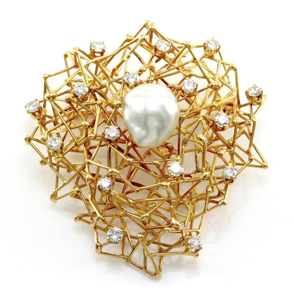 Signed Designer Boris Lebeau diamond bird nest pendant/ brooch with South Sea pearl accent in high polished 18K yellow gold. There is one baroque white south sea pearl, with a silver orientation measuring 16.7mm x 14.2mm. There are sixteen, prong