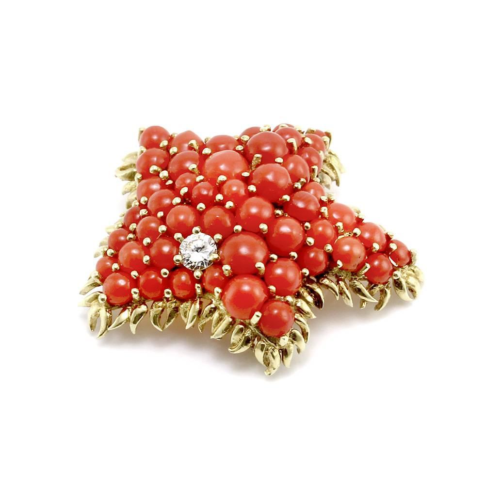 1960s signed designer Tiffany & Co. coral cabochon cluster with diamond starfish brooch set in 18K yellow gold. There are forty-seven round coral cabochons (2.5mm-4.5mm) and one round brilliant cut diamond (0.17ct) with a color of G and a clarity of
