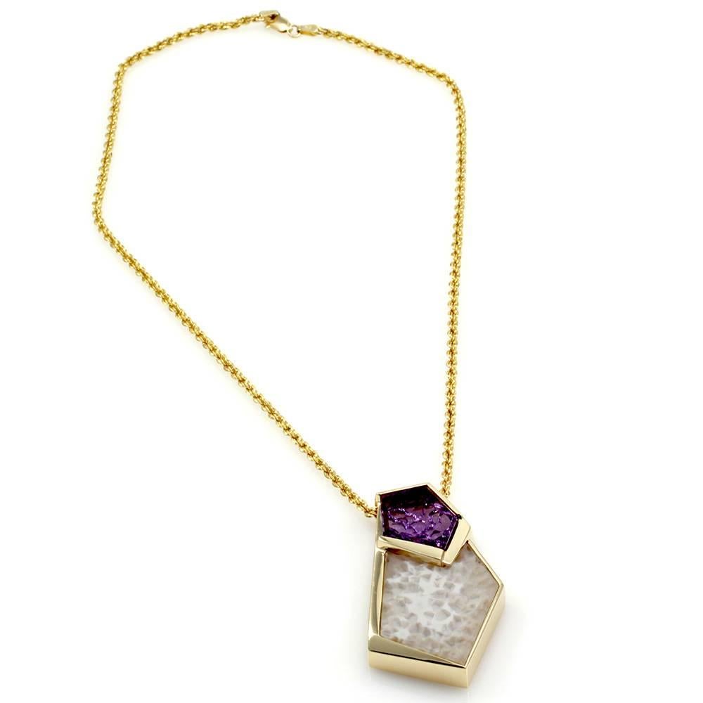 Bezel set amethyst and white quartz druzy pendant with rope style chain in high polished 14K yellow gold. The carved amethyst is in the shape of an elongated pentagon. The white quartz druzy has a glass plate displaying the matrix and is in the