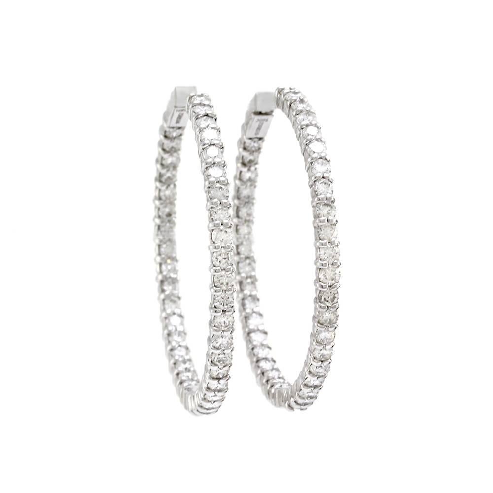 Early Roberto Coin Perfect Diamond Hoops, inside-out earrings in high polished 18K white gold. There are seventy-six prong set, round brilliant cut diamonds with a color of H-I and a clarity of VS-SI1. Each earring measures 37.4mm x 2.9mm and are