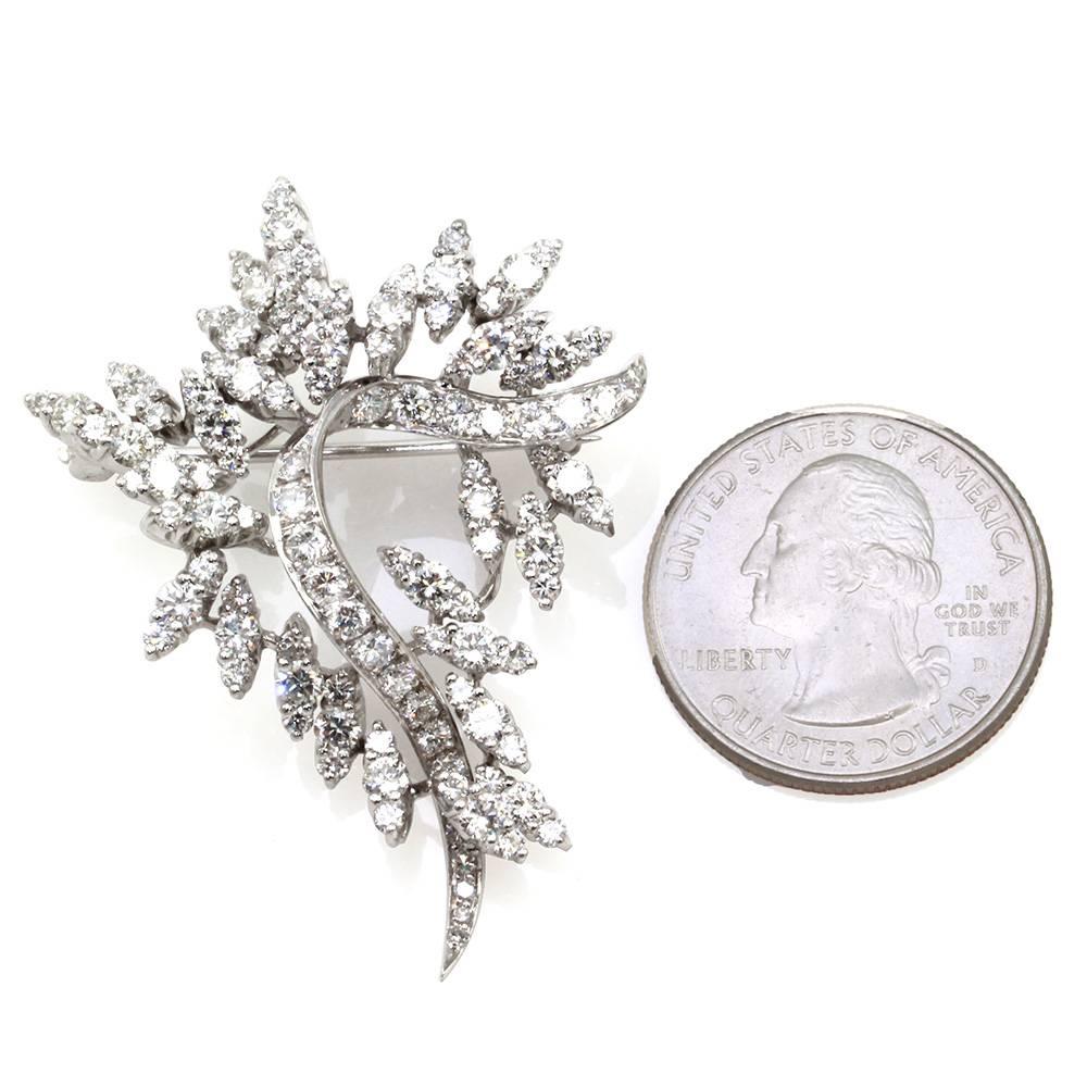 Vintage mid-century diamond floral spray pin/ brooch in high polished 14K white gold. There are one hundred fourteen bead set, round brilliant cut diamonds (5.06ctw) with a color of H- I and a clarity of VS- SI. The pin measures 48.8mm x 36.4mm,