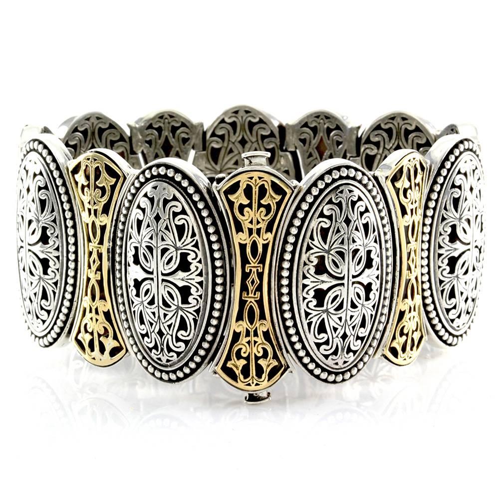 Signed designer Phillip Gavriel Byzantine collection bracelet in high polished sterling silver and 18K yellow gold. This bracelet measures 34.87mm wide and is finished with a double push button closure. This item is 7 inches end to end, with a total